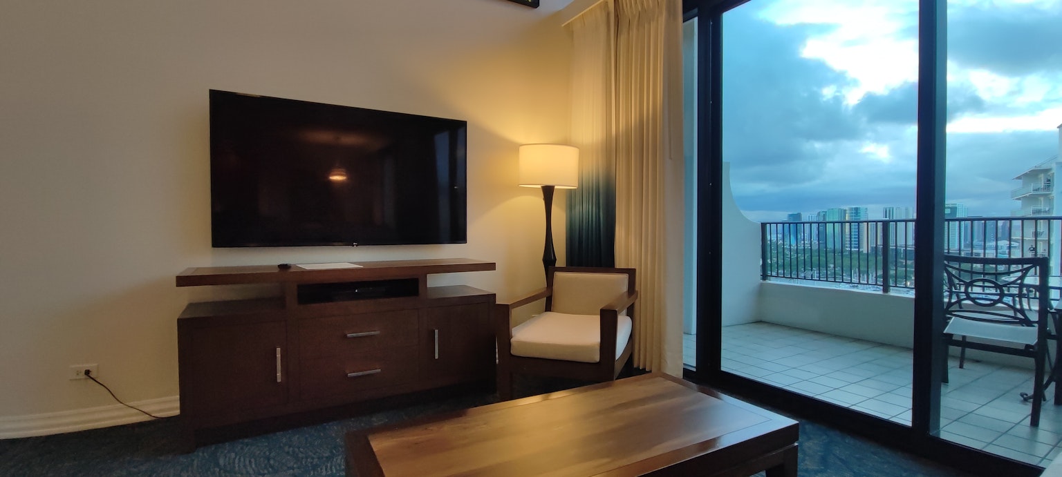 Intérieur moderne de salon avec télévision et fauteuil surplombant une vue de balcon