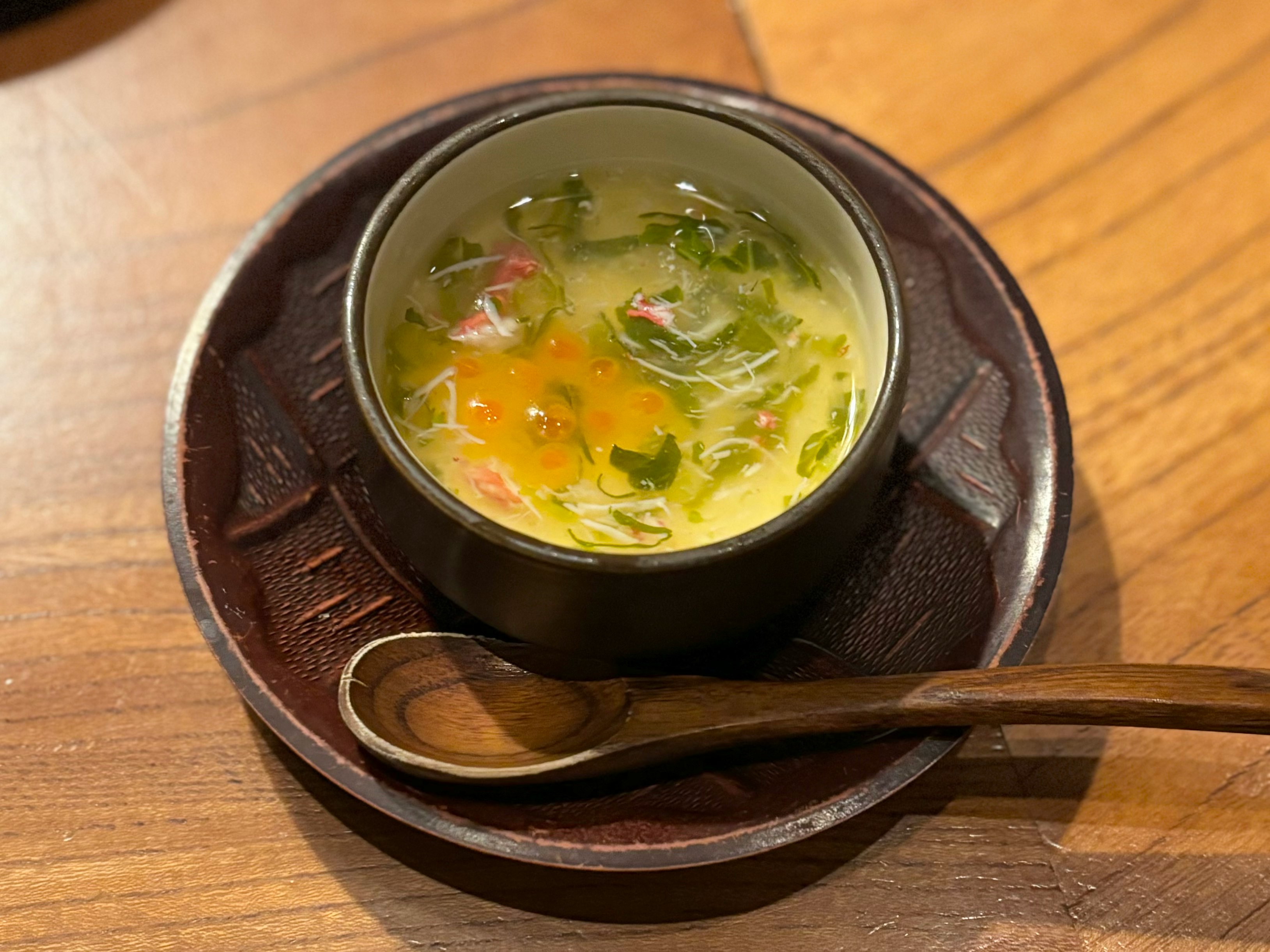 bowl of vegetable soup on a wooden table