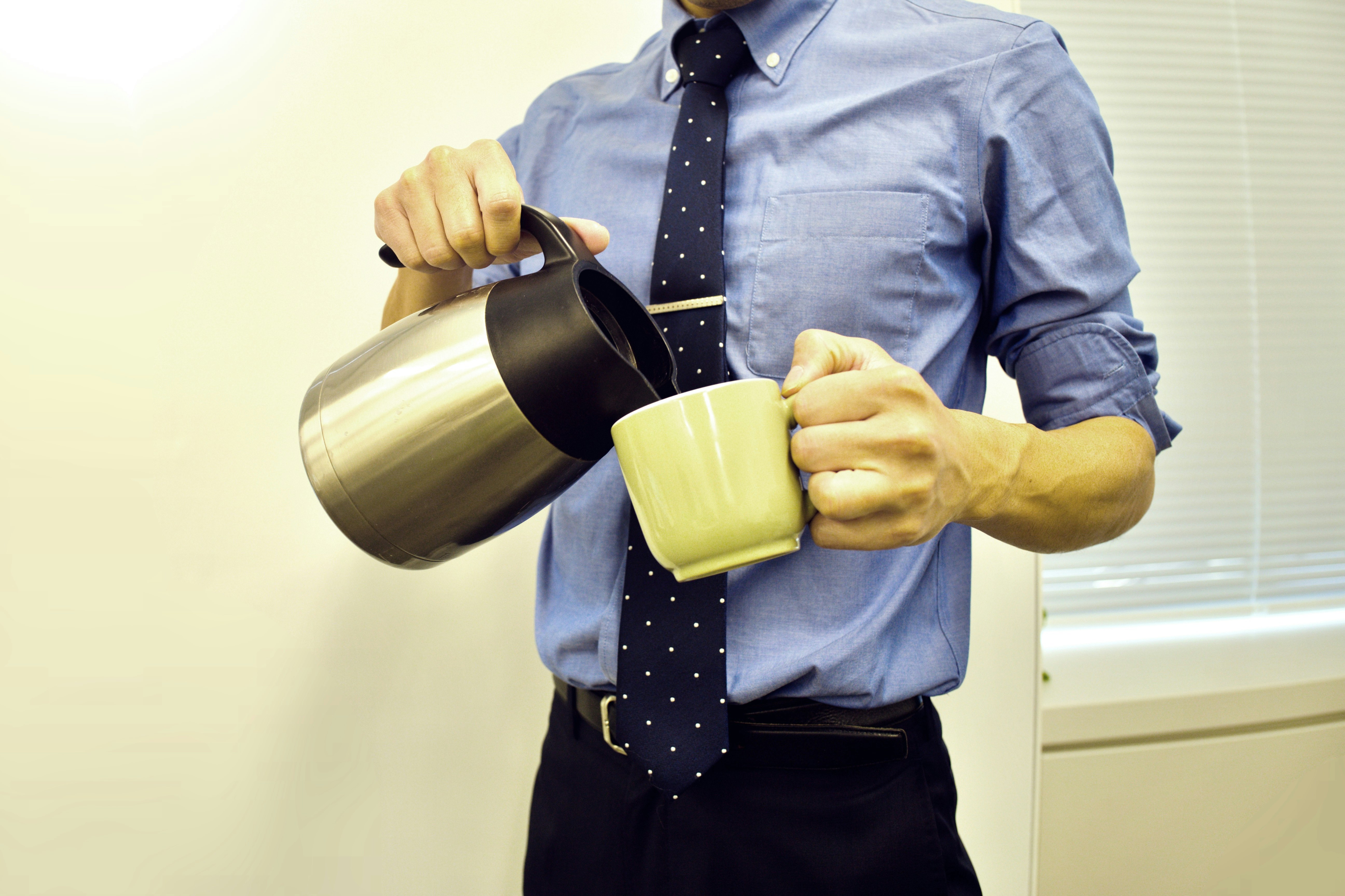 hombre de negocios sirviendo café en una taza