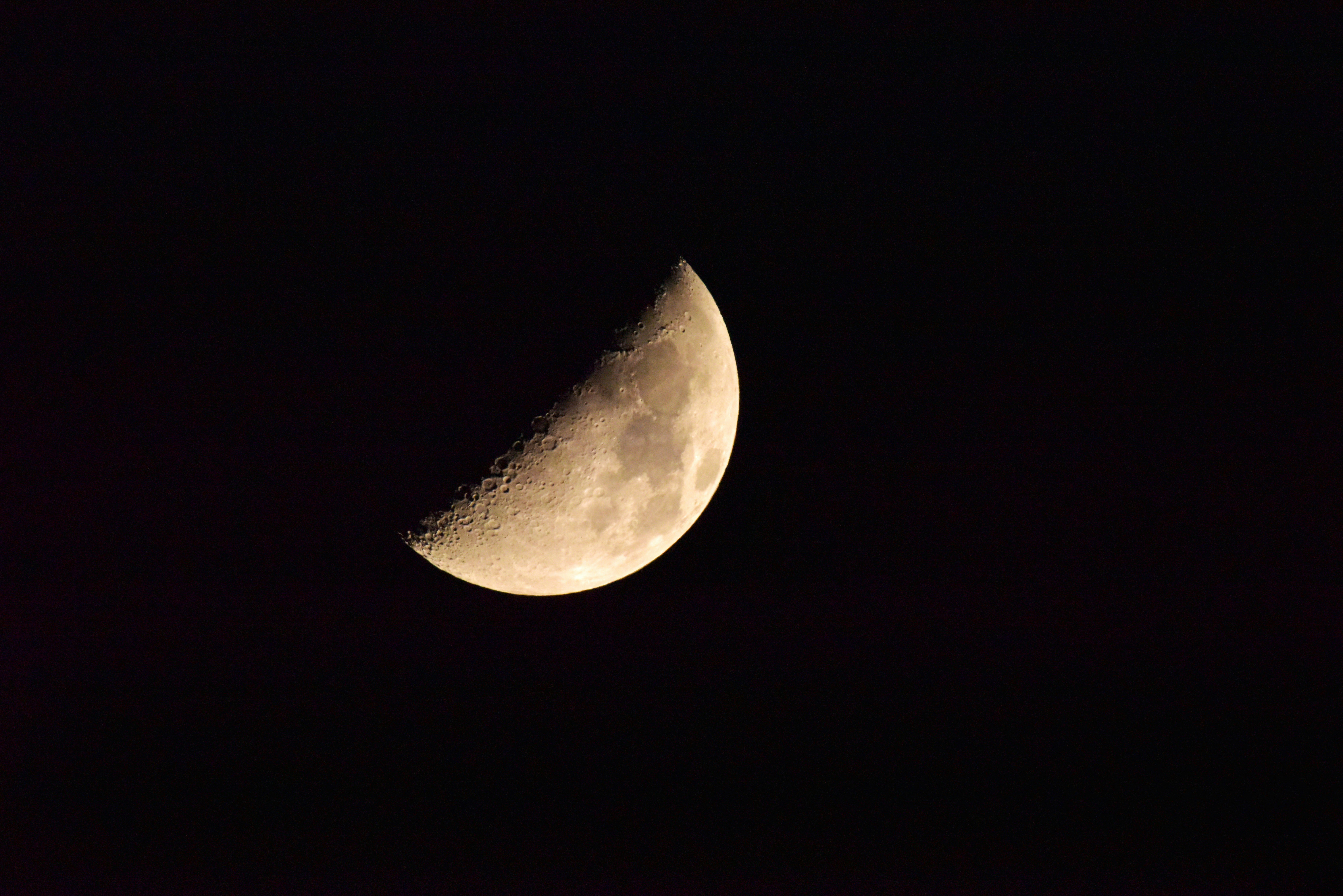 crescent moon floating against a dark background