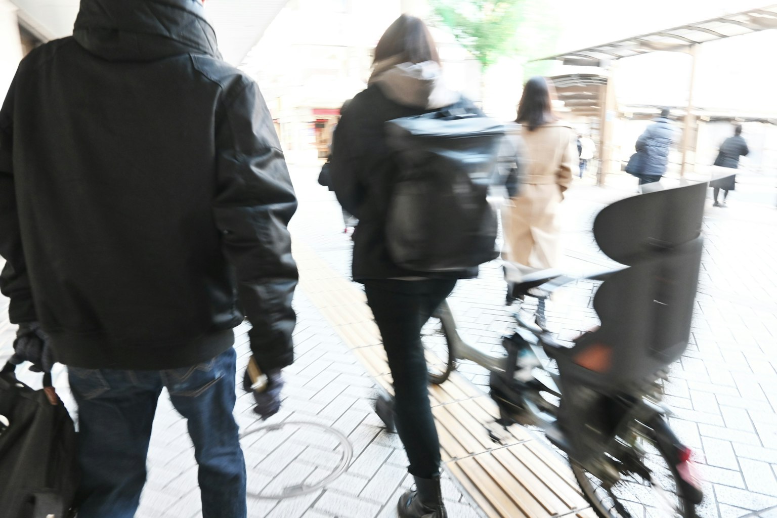 Personas caminando cerca de una bicicleta en un entorno urbano