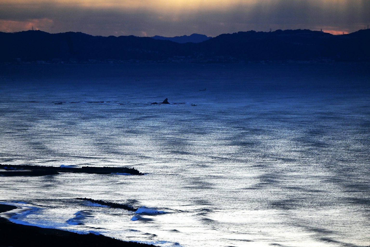 Expansive ocean with blue wave reflections soft twilight light
