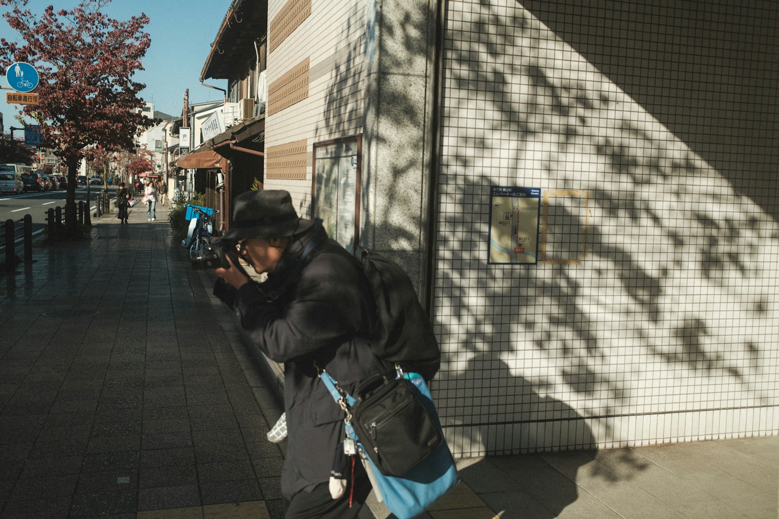 Person taking a photo with shadows on the wall