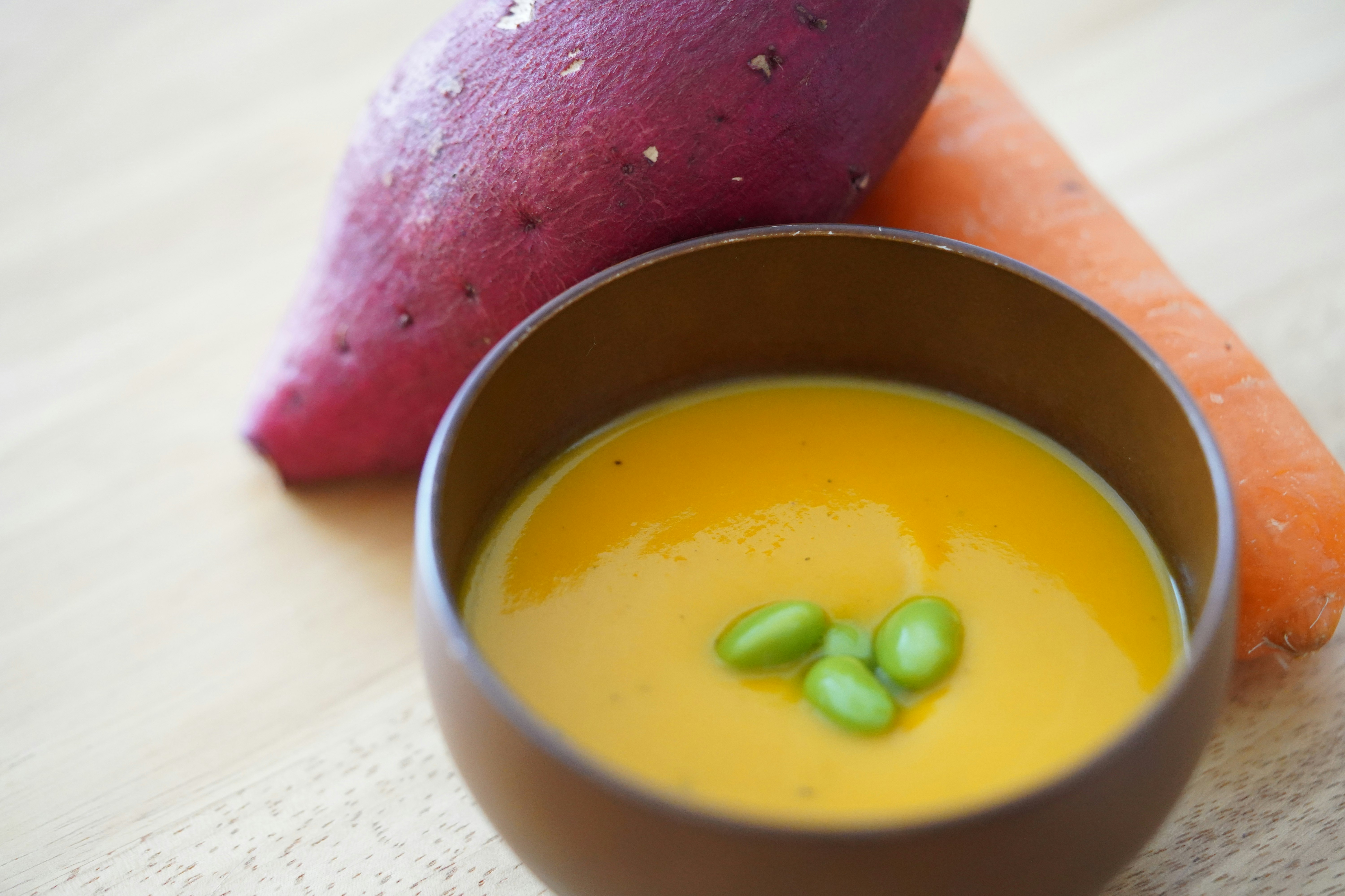 bowl of soup with watermelon and carrot garnish