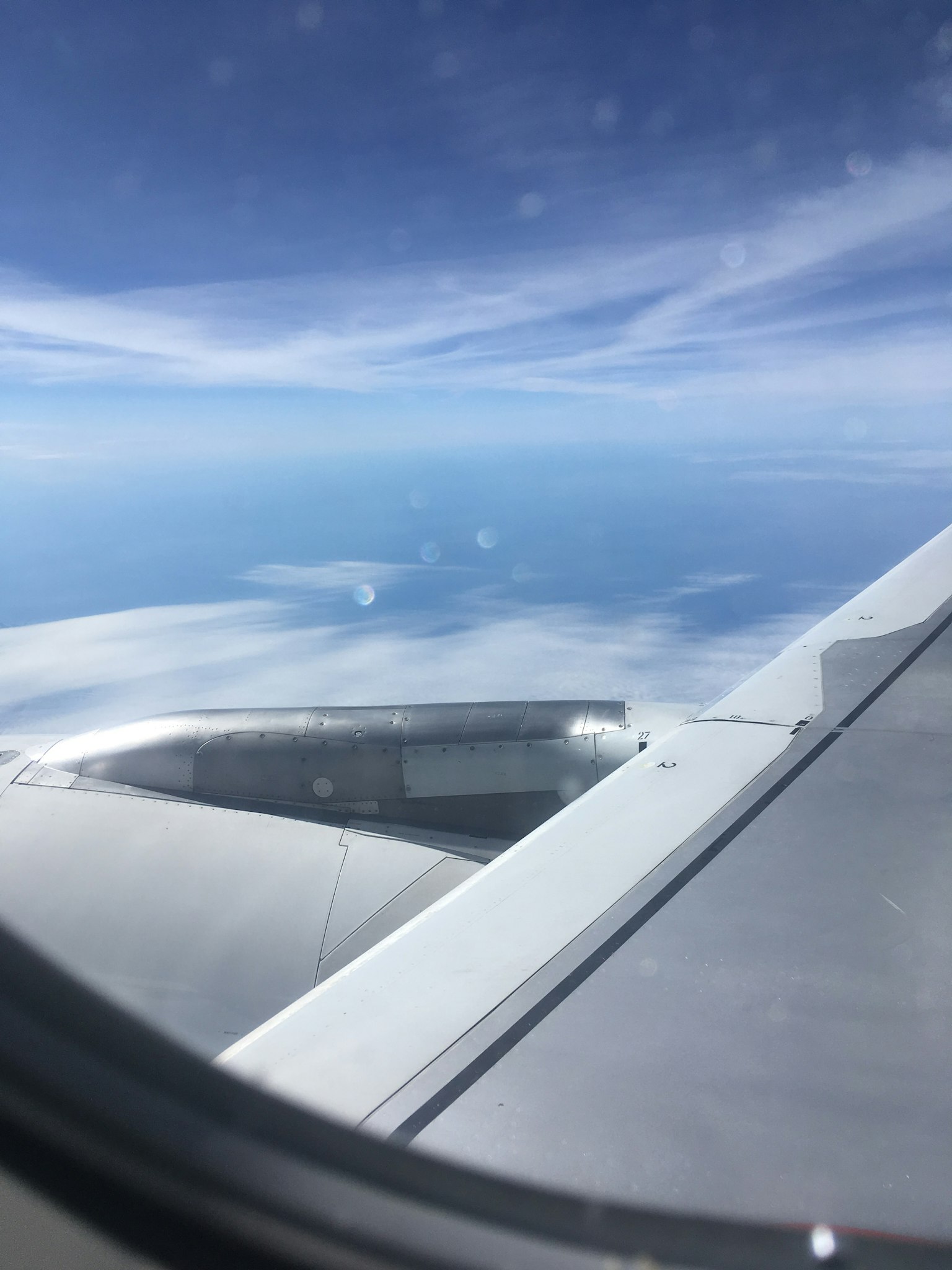 View of blue sky and clouds from an airplane window