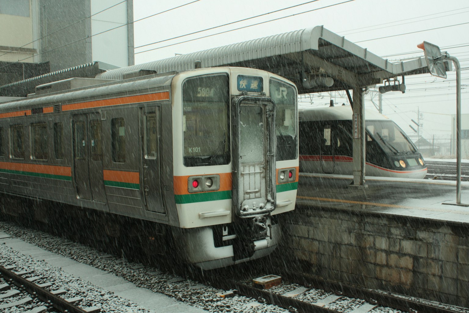 Train at a snowy station with visible tracks