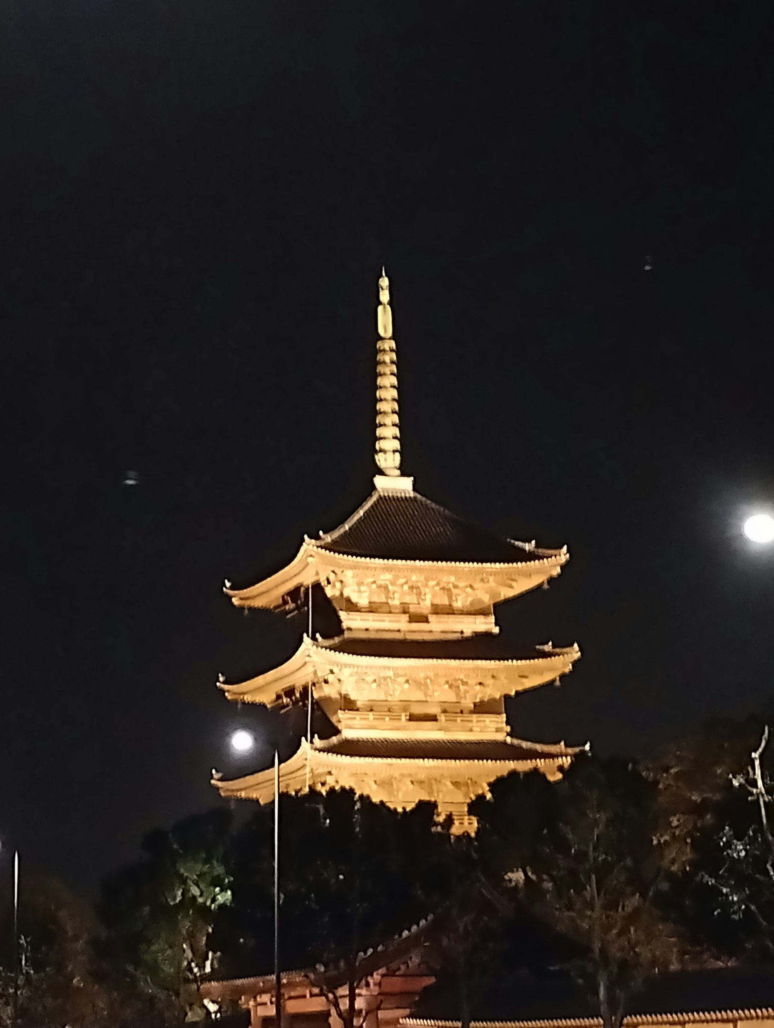 Beautiful view of a pagoda at night with a bright moon