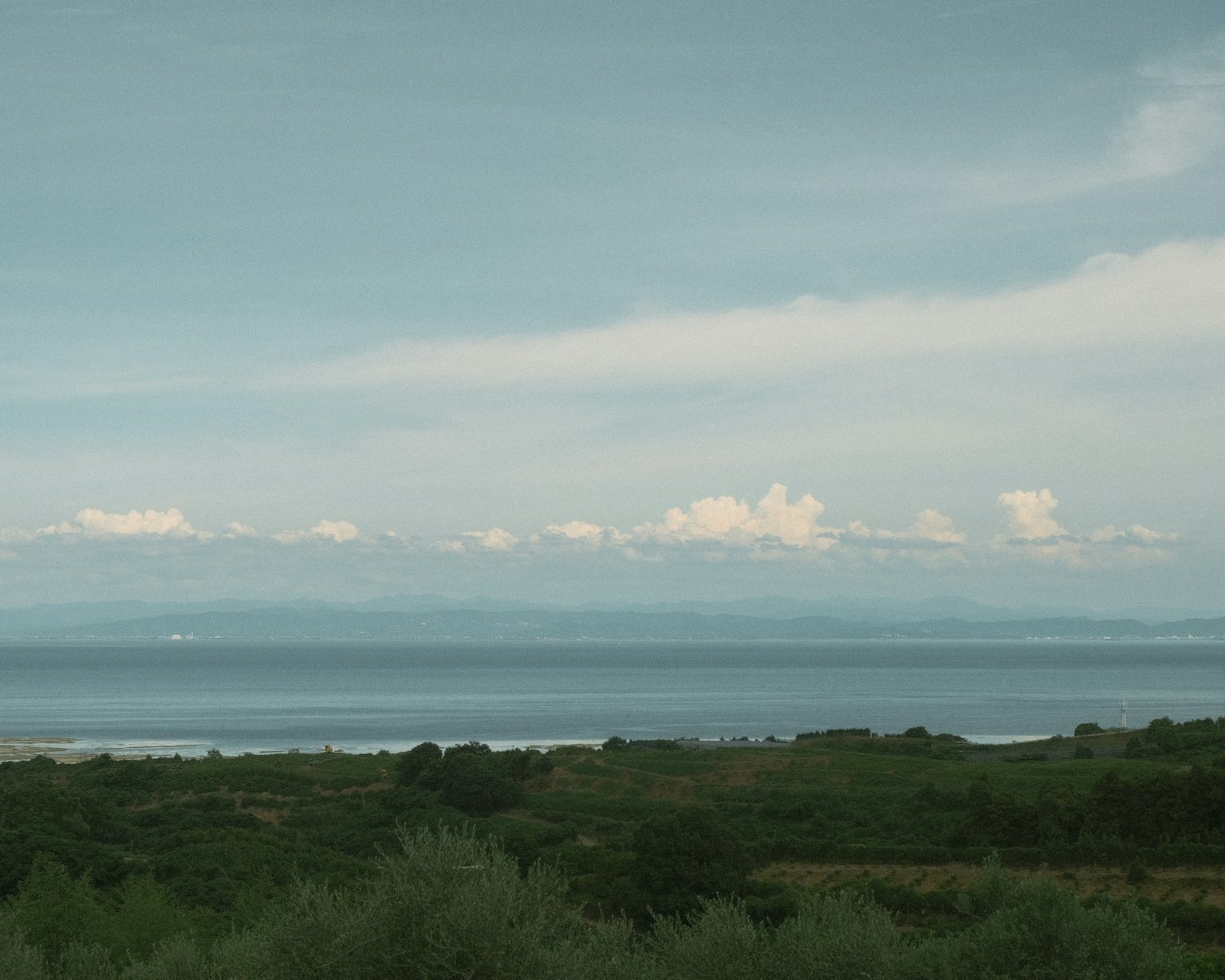 Serene view of the sea with clouds in the sky
