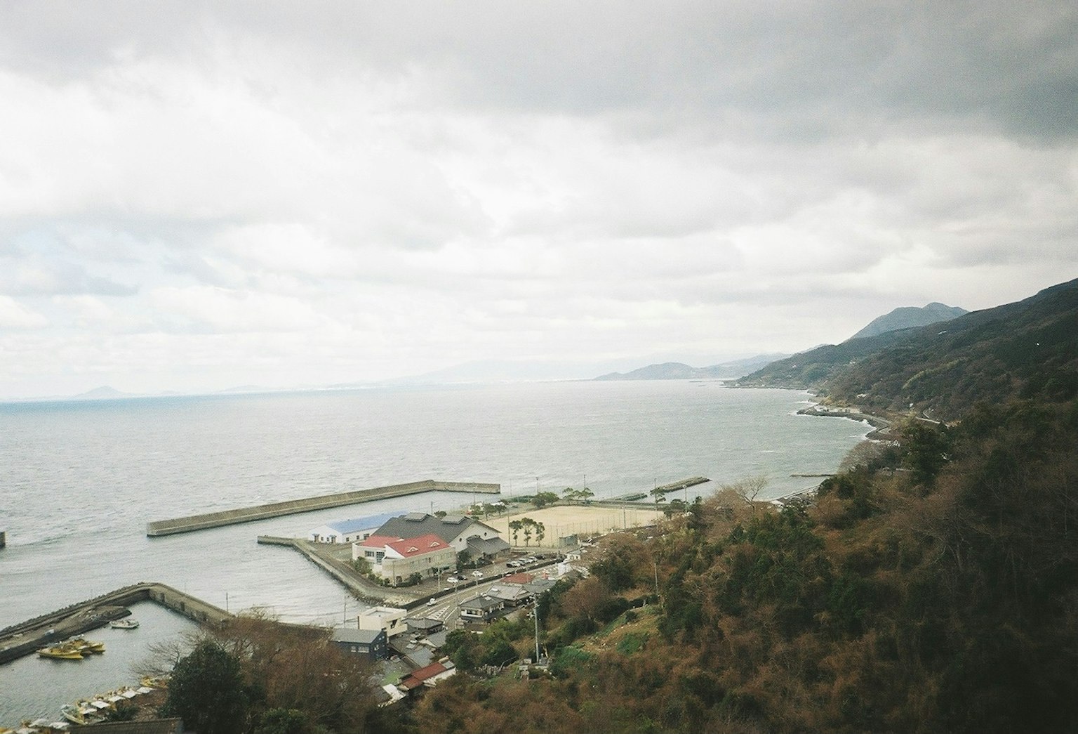 海岸景觀，港口在多雲的天空和寧靜的海面下