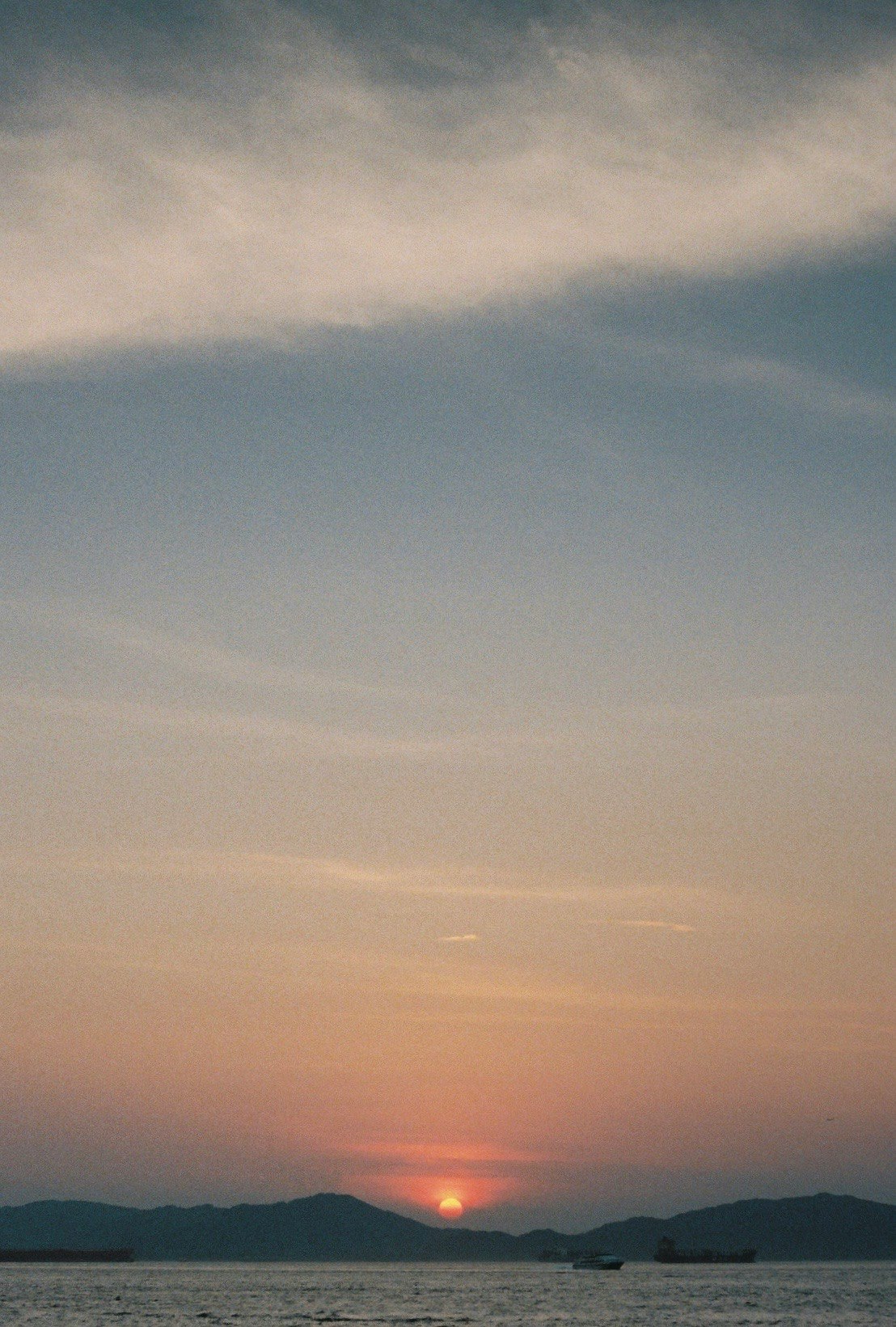 水平線に沈む夕日と雲の空