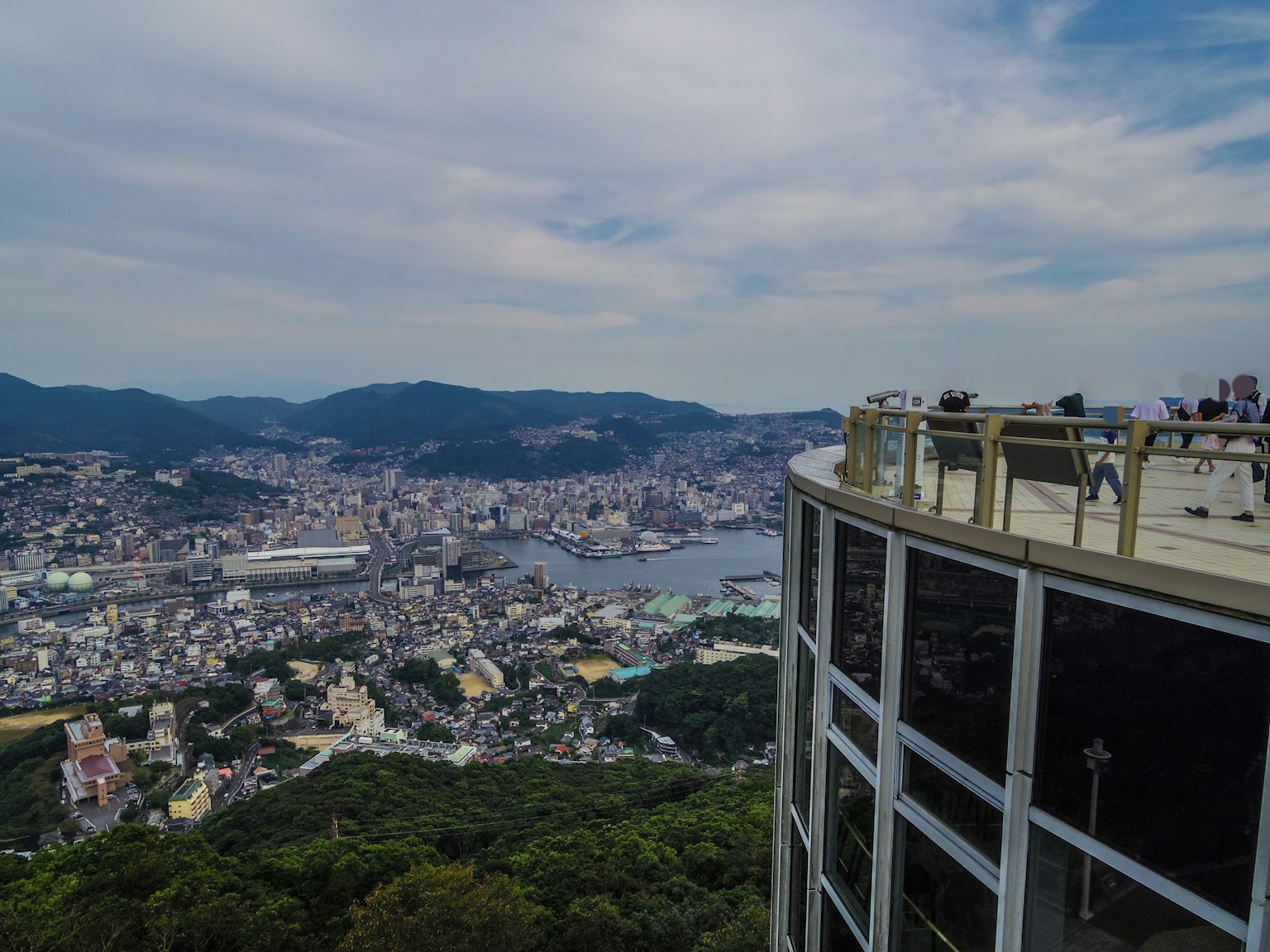 Scenic view from an observation deck overlooking Nagasaki's harbor and mountains