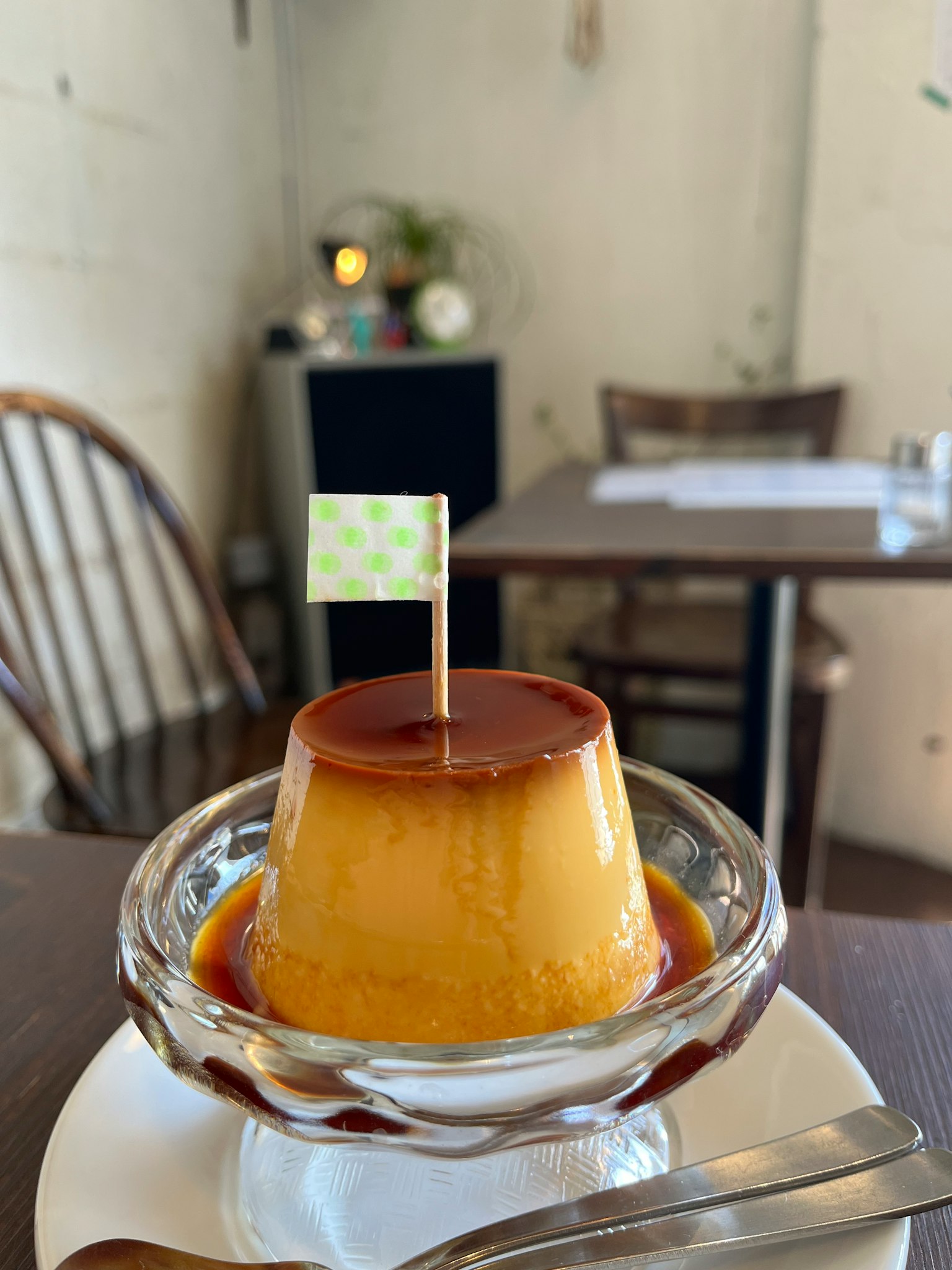 Flan dessert with caramel sauce and a small flag on top