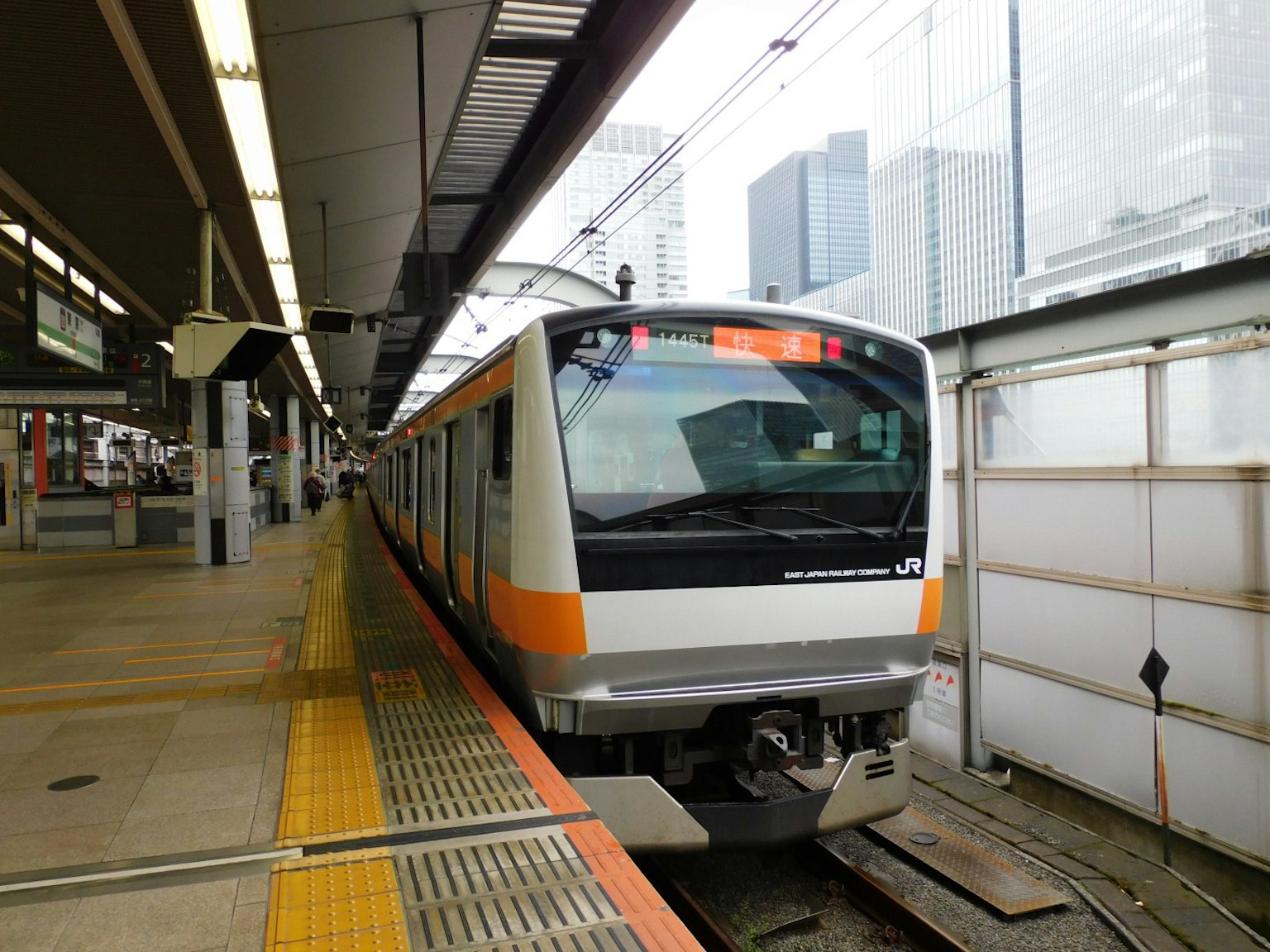 Orange and white train parked at the station