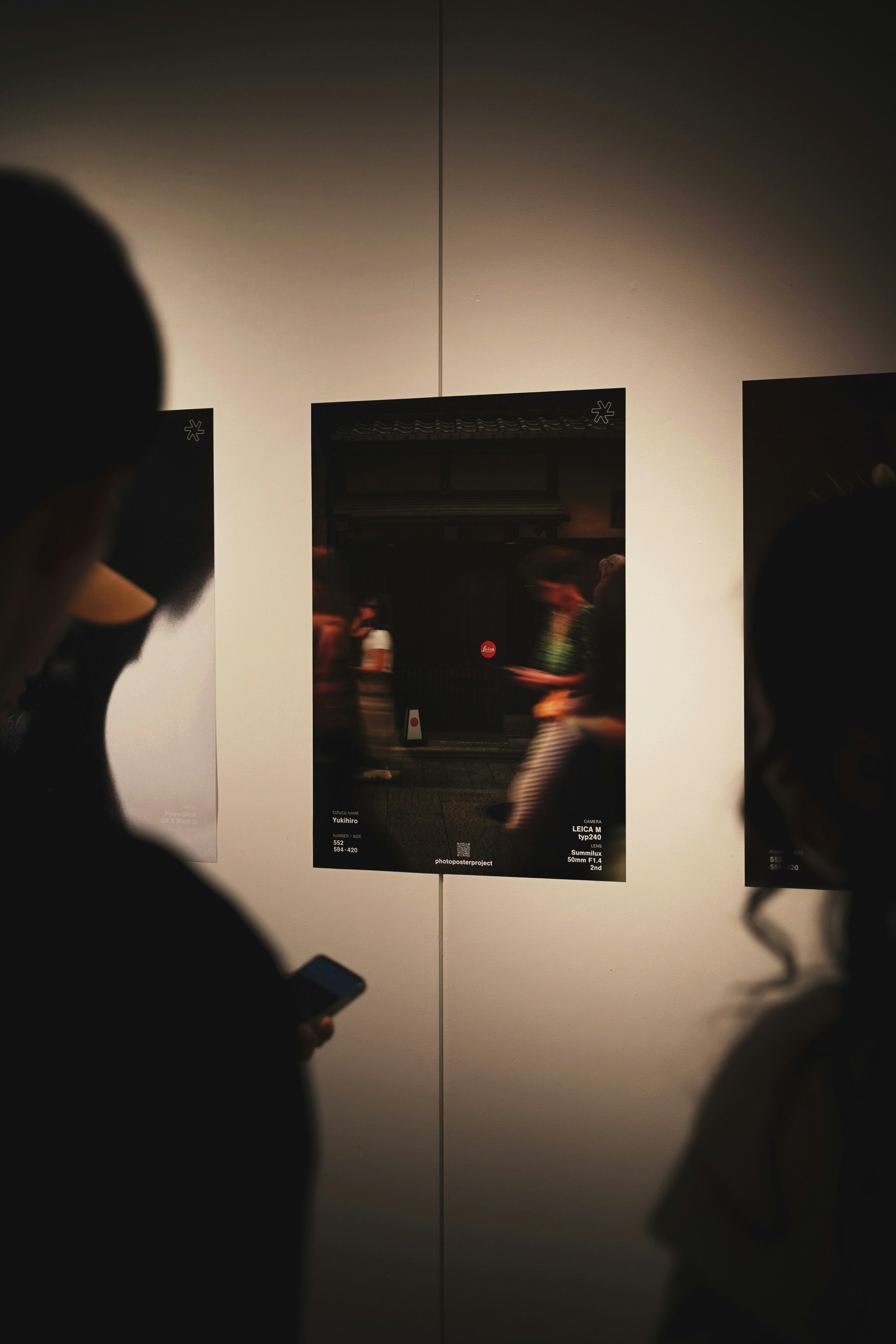 poster fotografici esposti su una parete di galleria