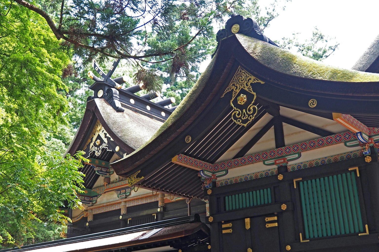 Beautiful shrine roof with intricate decorations in a lush green setting