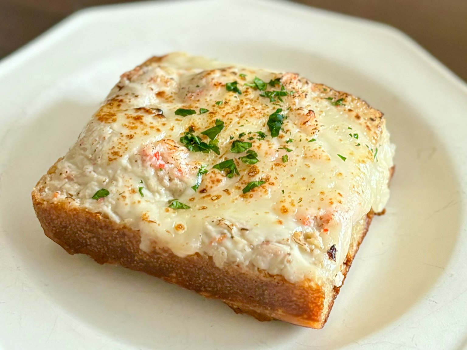 Toasted bread topped with creamy spread and herbs