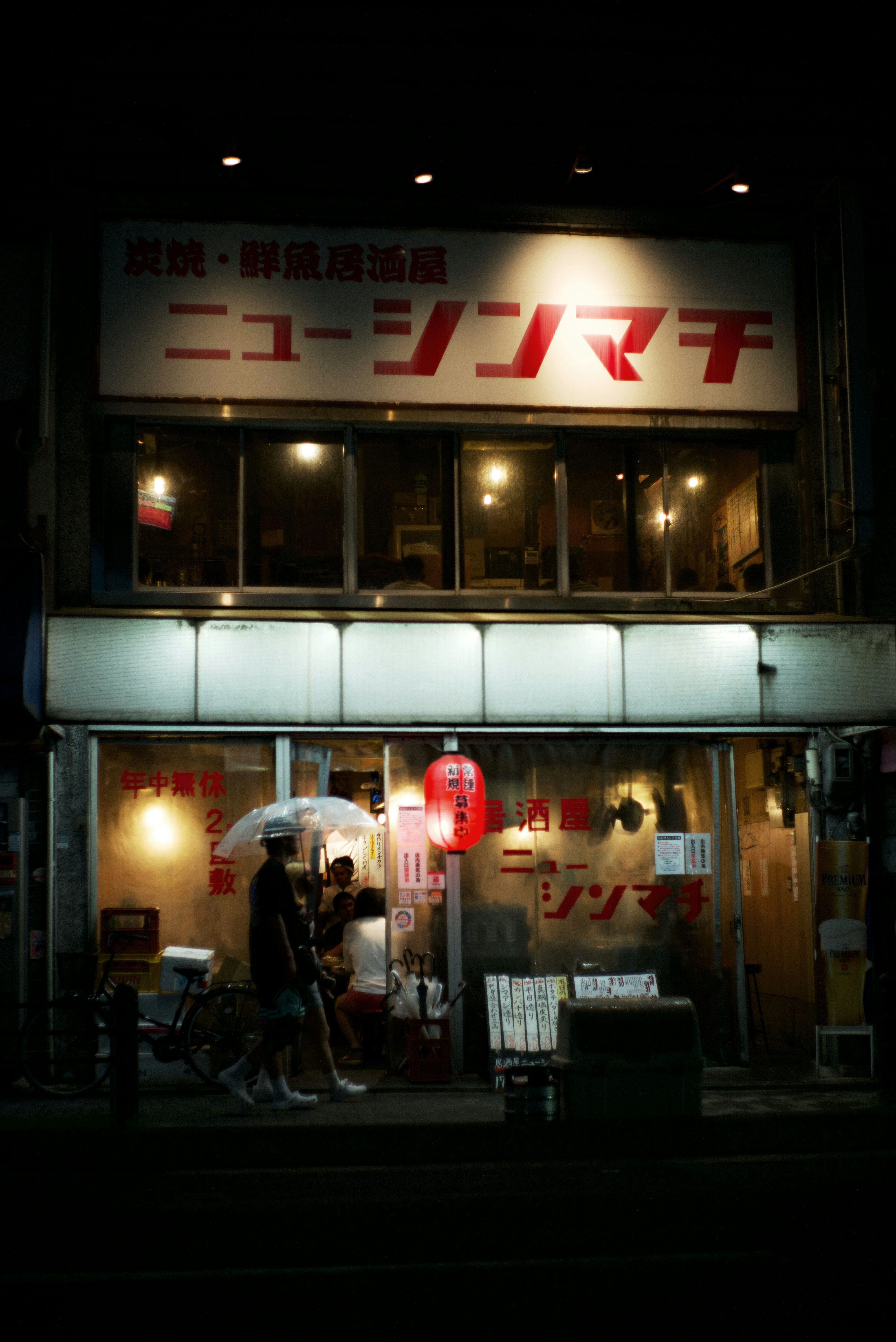夜の看板が光る飲食店のある路地の外観