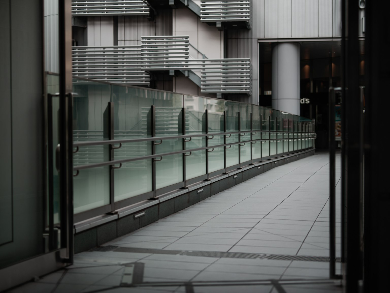 Passerelle moderne avec garde-corps en verre et éléments architecturaux