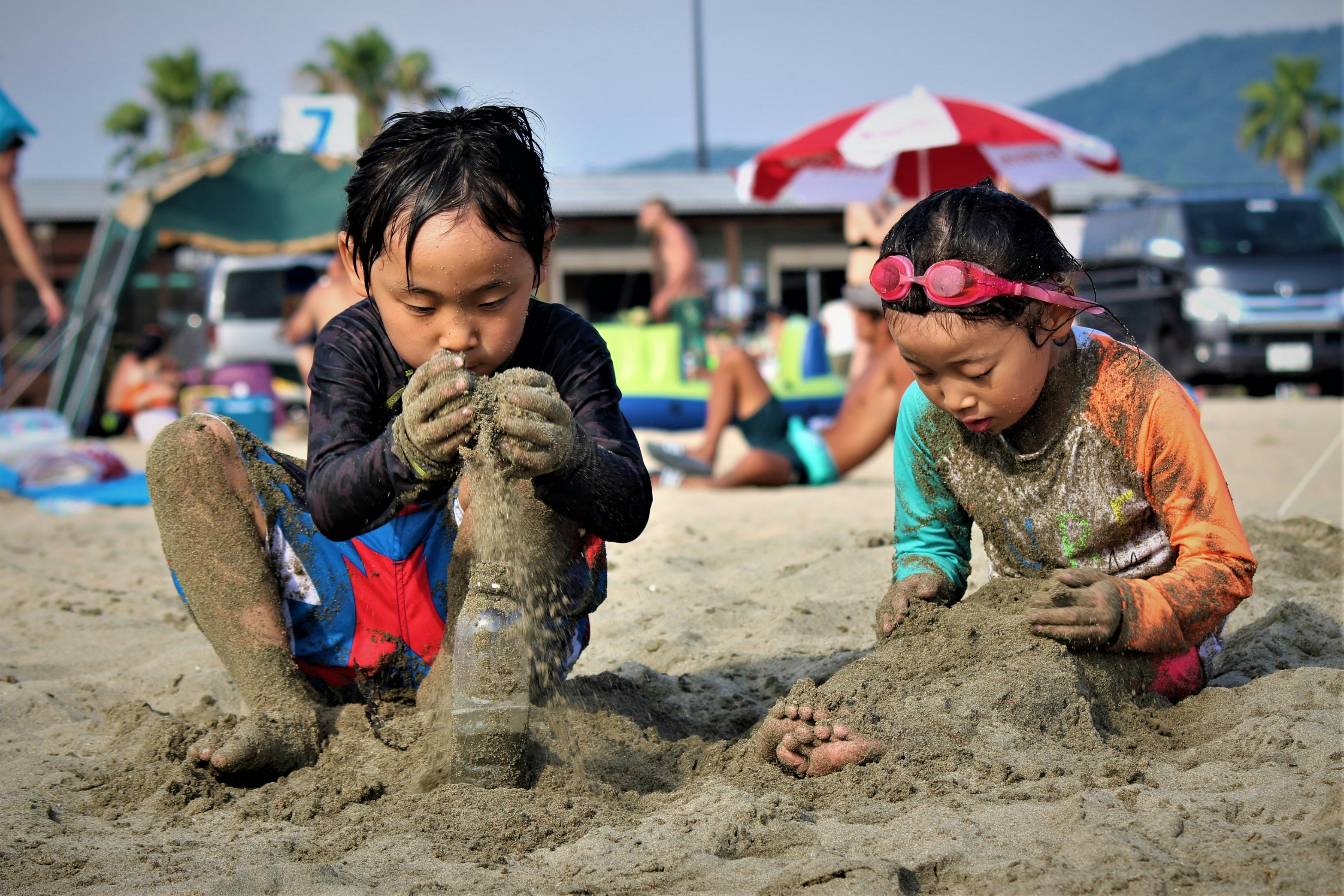 children playing in the sand on a beach