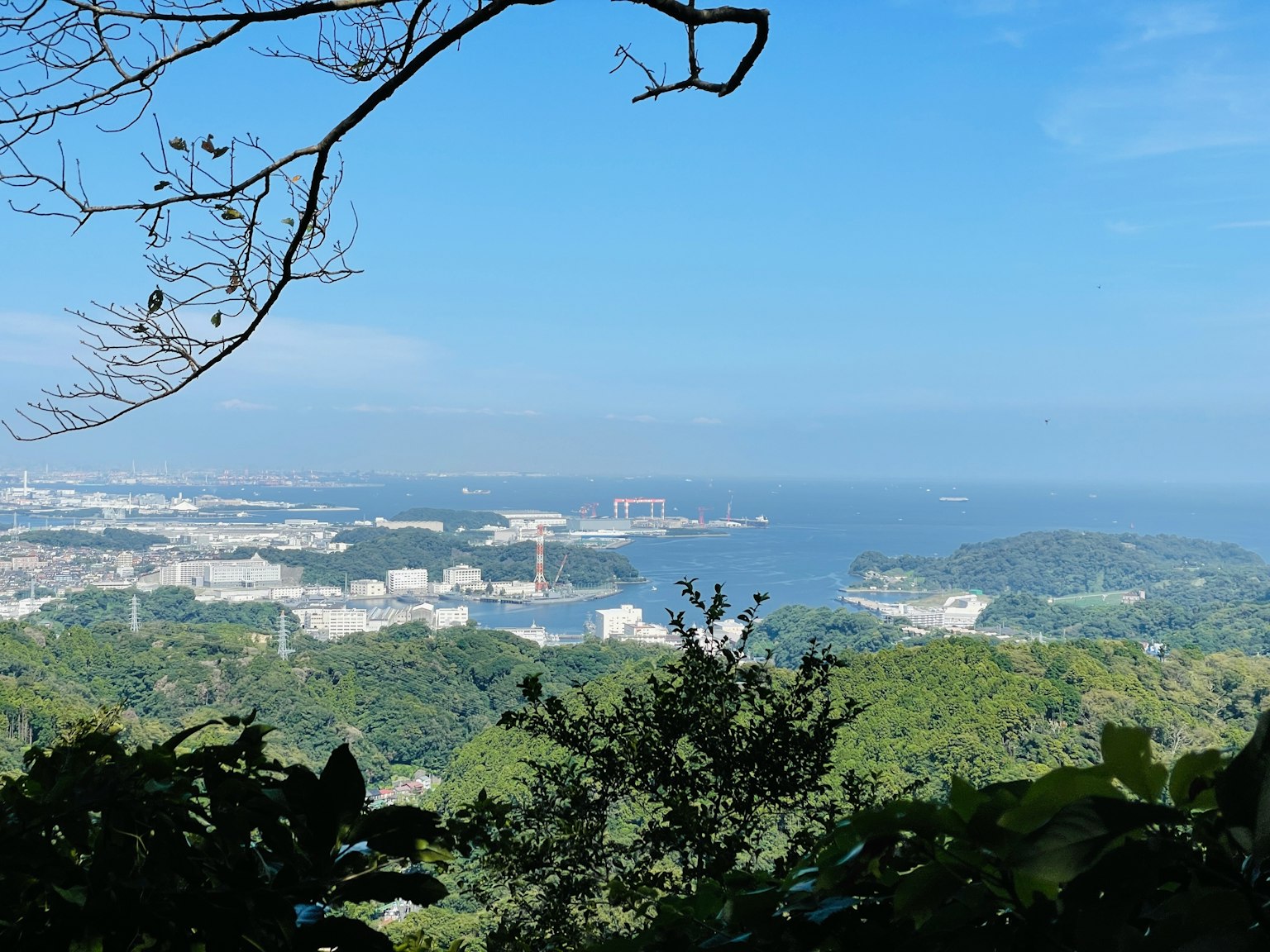 View from a mountain top overlooking the sea and lush greenery