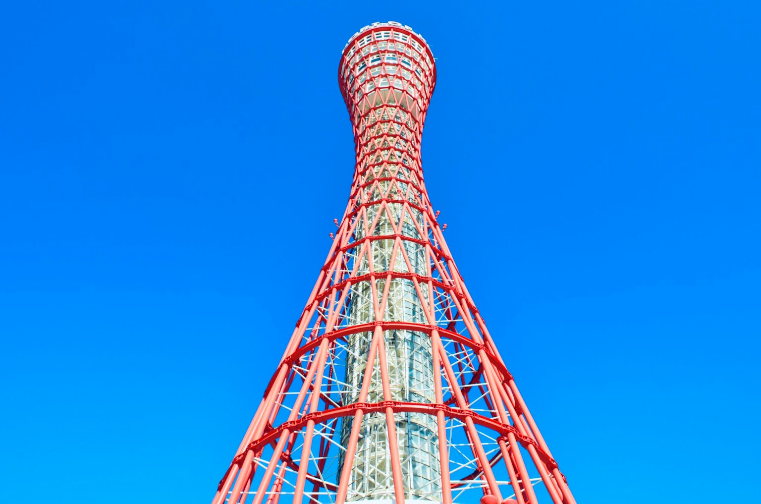 La struttura rossa della Torre di Kobe si staglia contro un cielo blu
