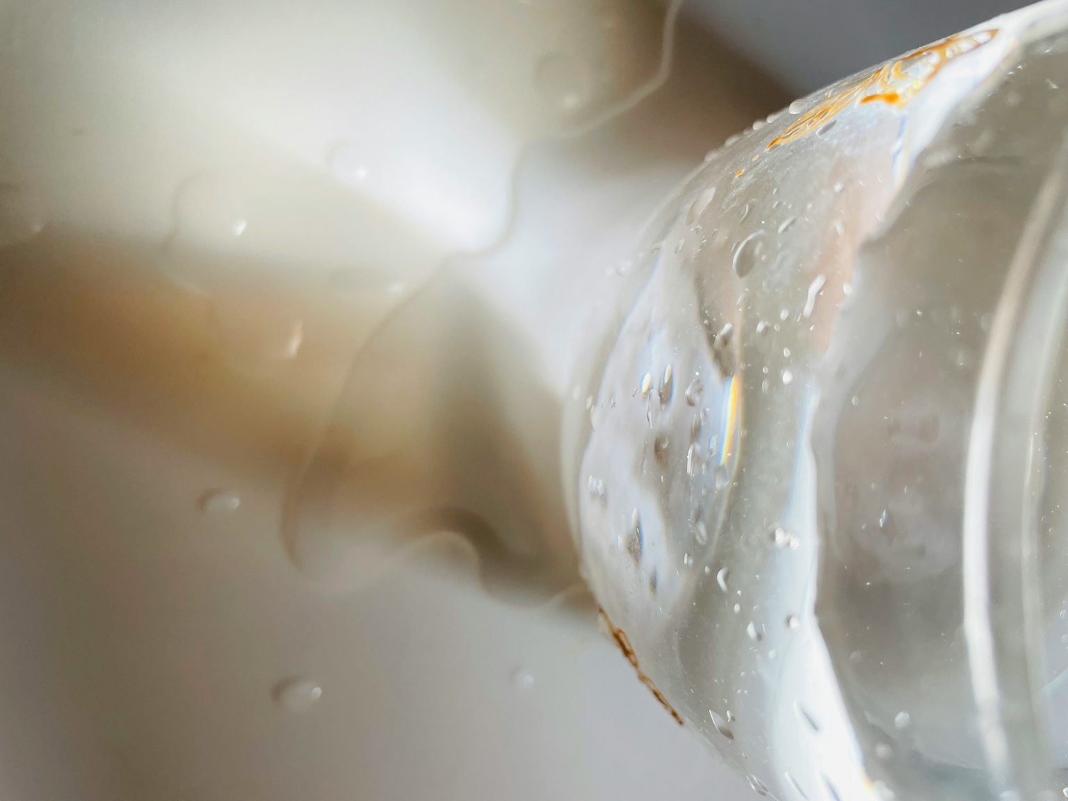 A clear glass containing water with a white background
