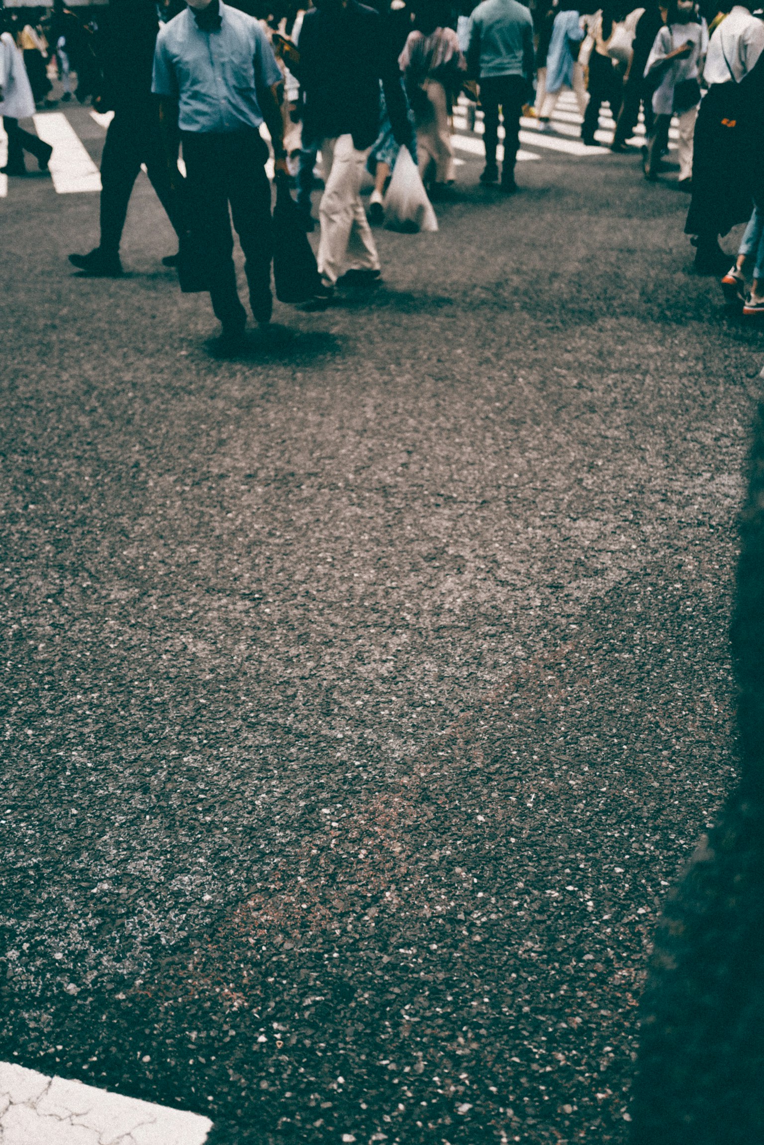 A busy street scene with people crossing at an intersection