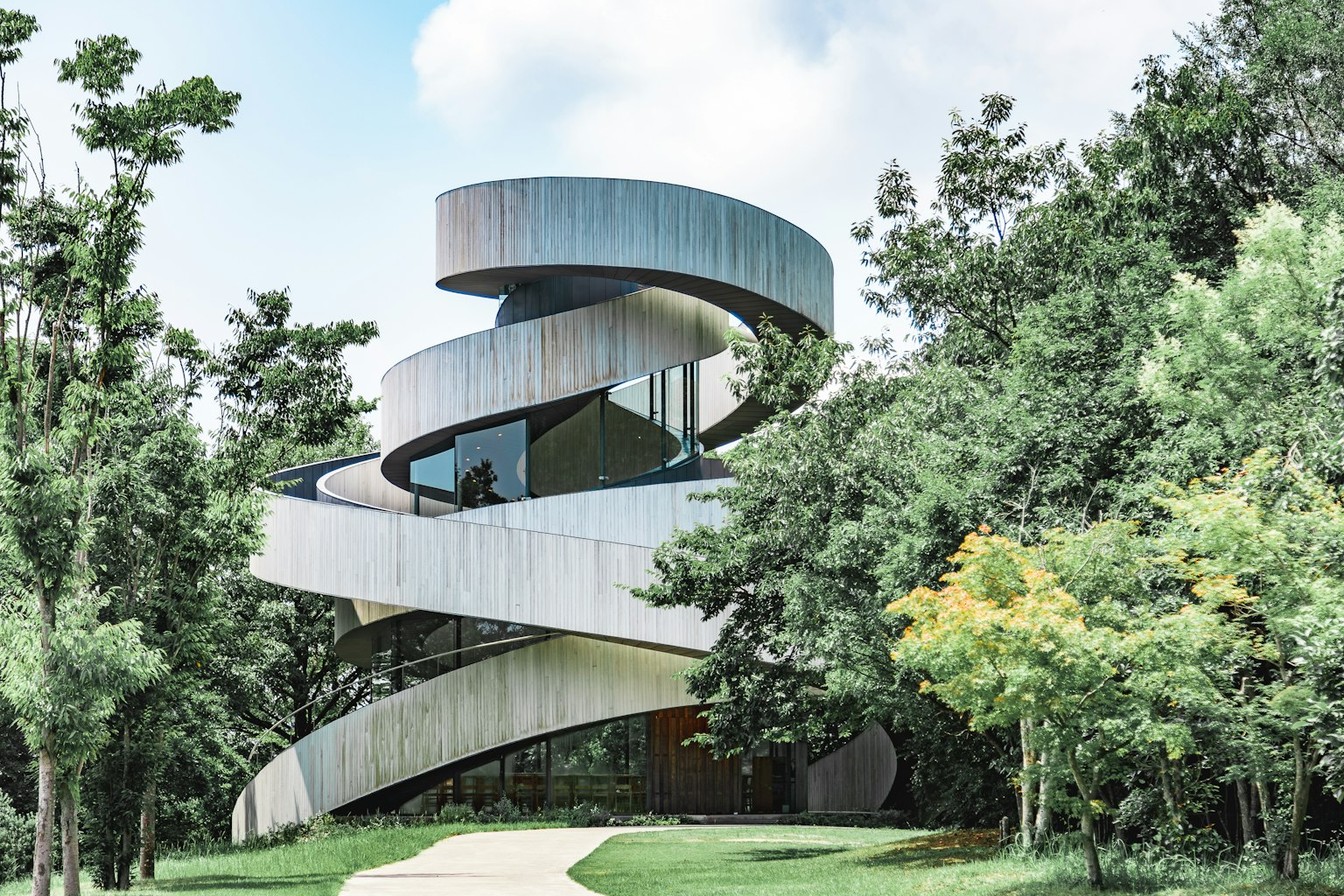 Edificio en forma de espiral único rodeado de vegetación exuberante