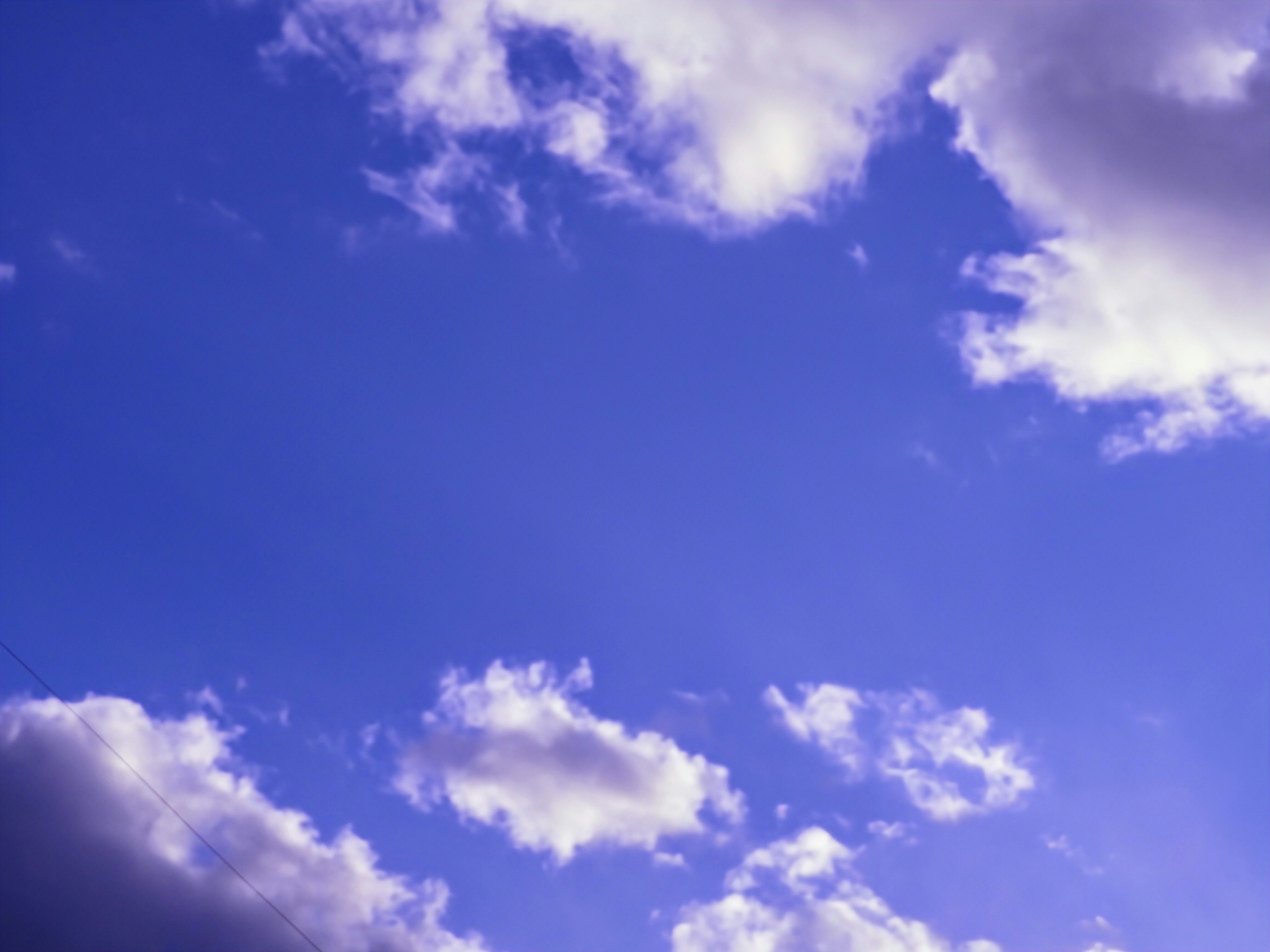 Expansive blue sky with scattered clouds