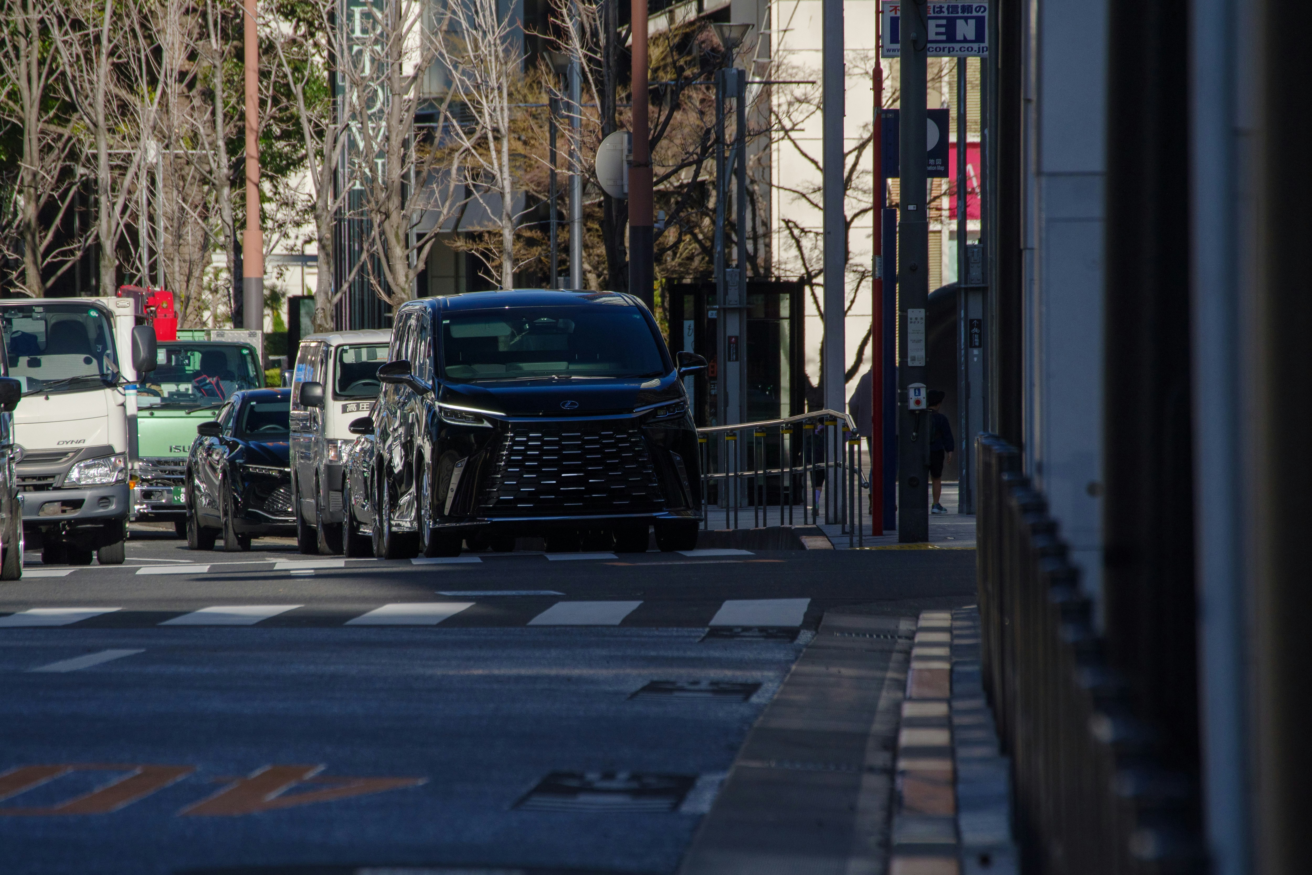front view of a luxury Lexus car driving on a city street