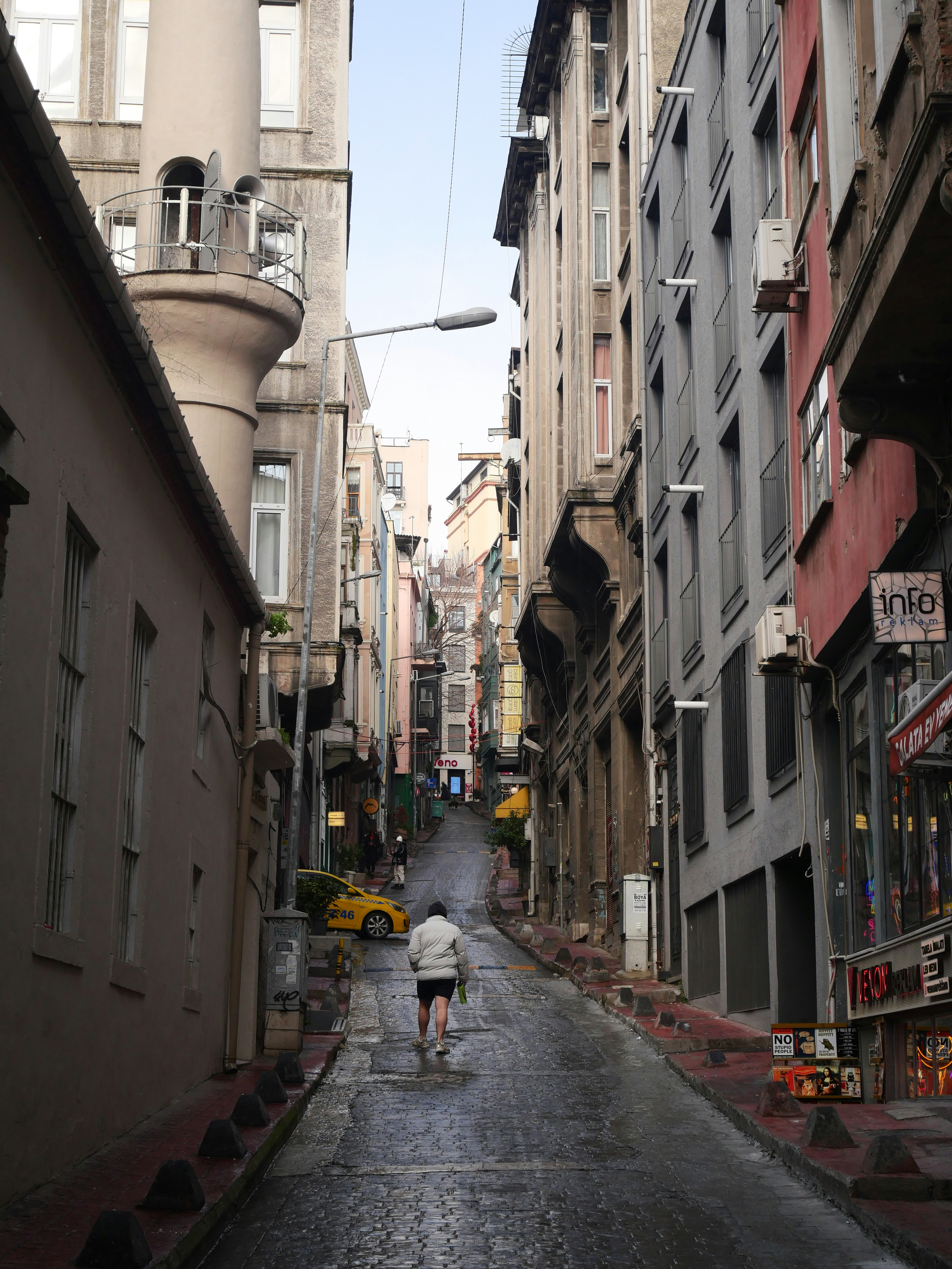 vicolo stretto di Istanbul con edifici e strada bagnata