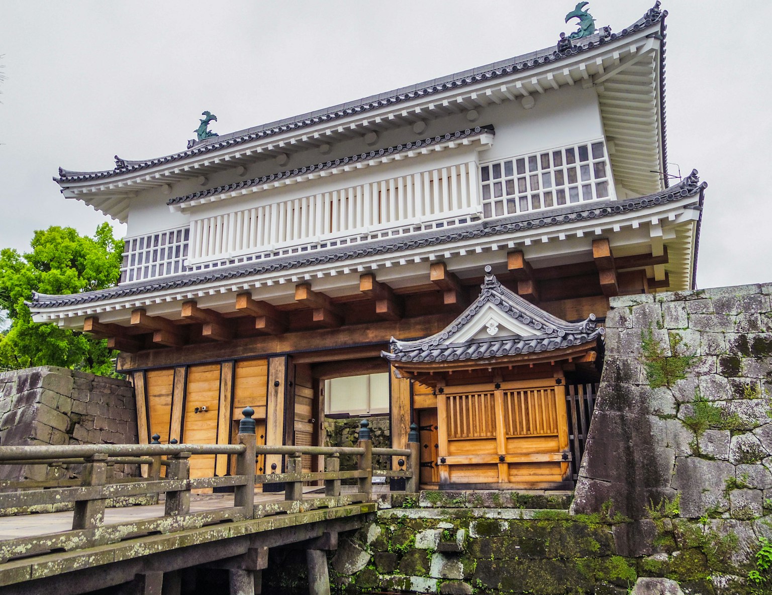 Beautiful traditional Japanese building featuring wooden bridge and stone walls