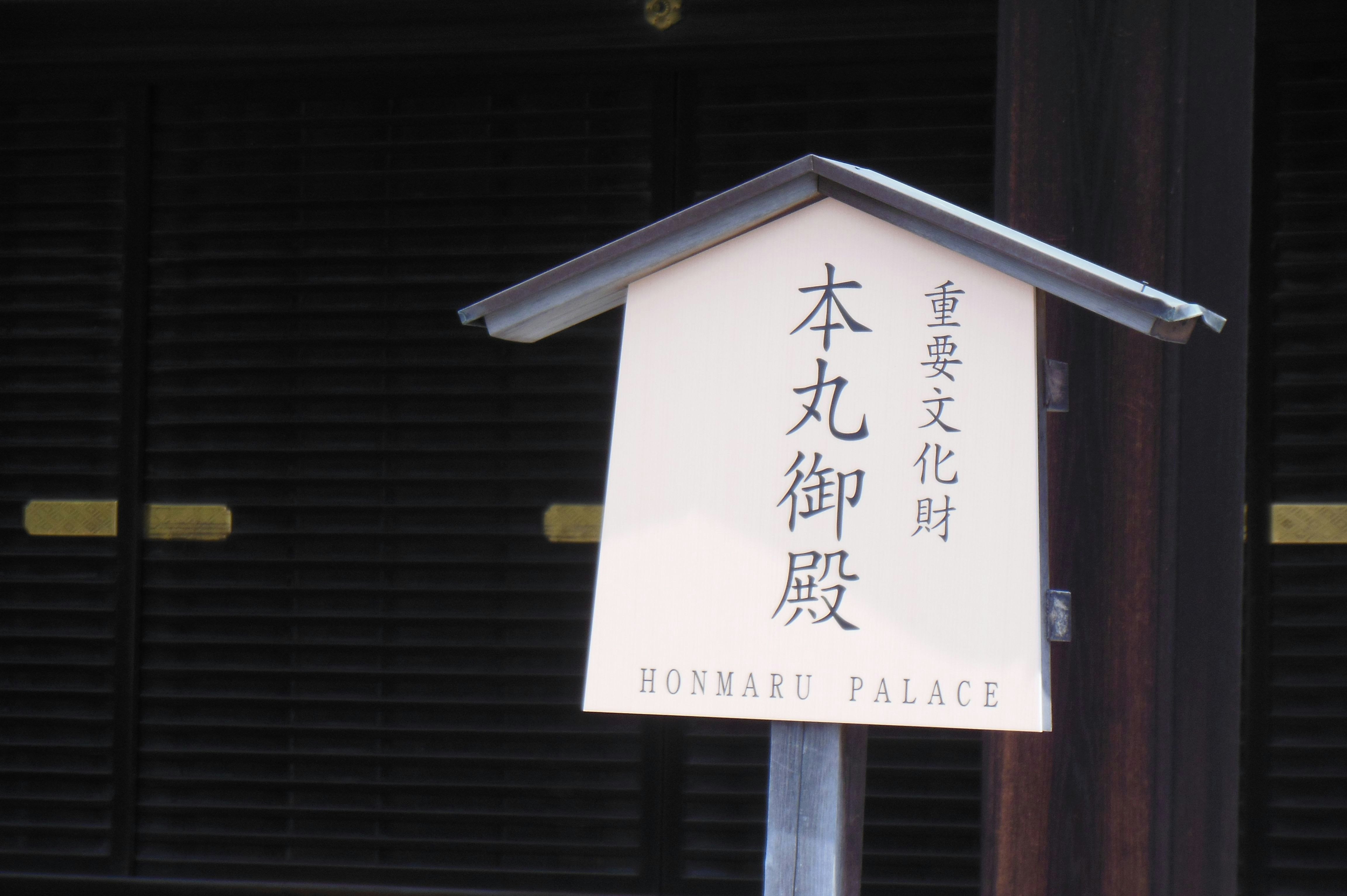 Un letrero del Honmaru Palace frente a una puerta