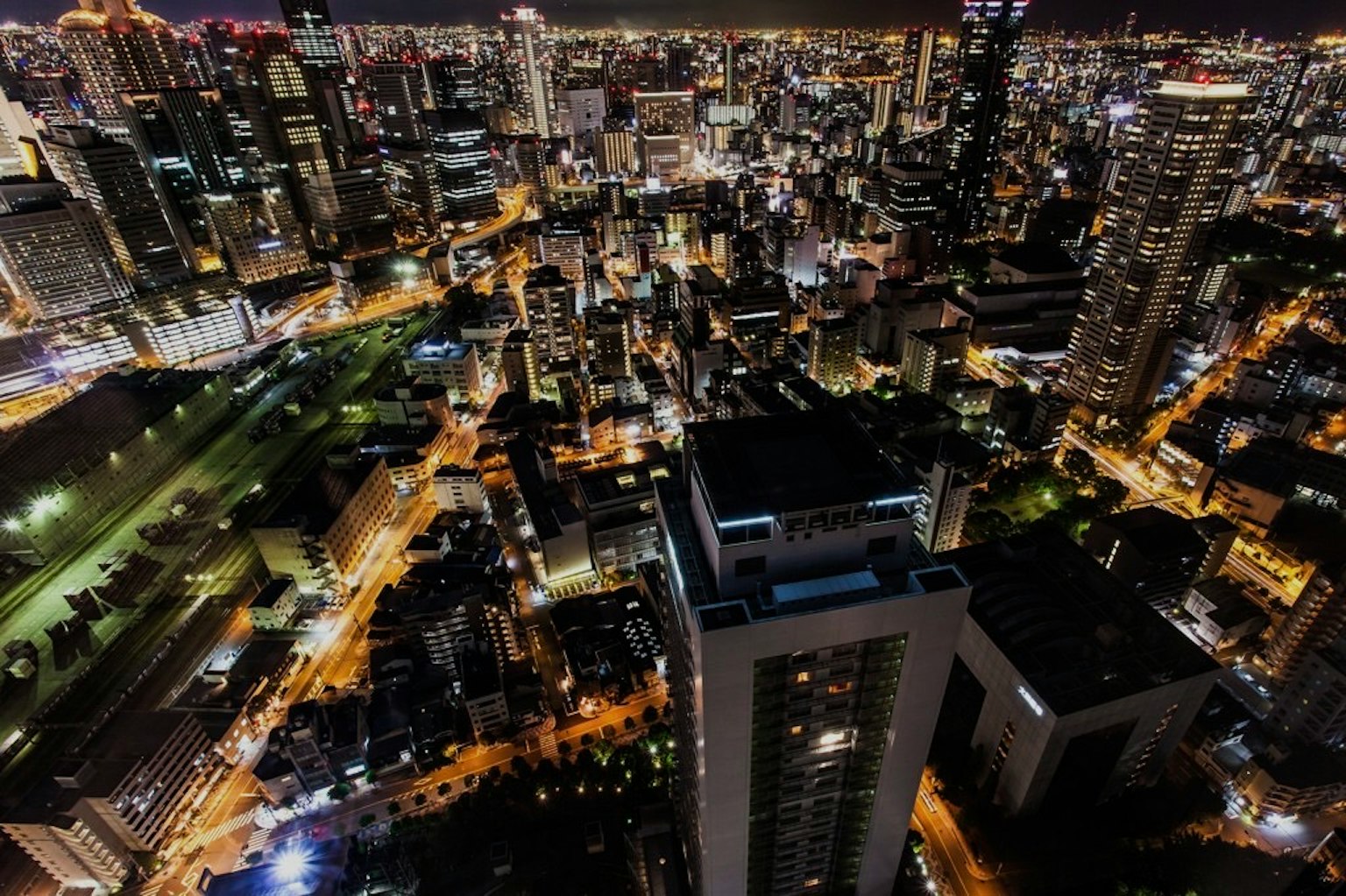 Vista notturna dello skyline di una città con edifici e strade illuminate