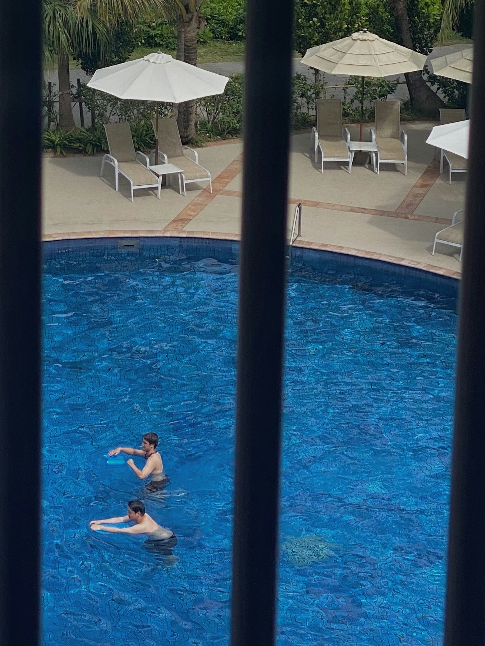 Resort poolside scene with people relaxing (Busena Terrace)