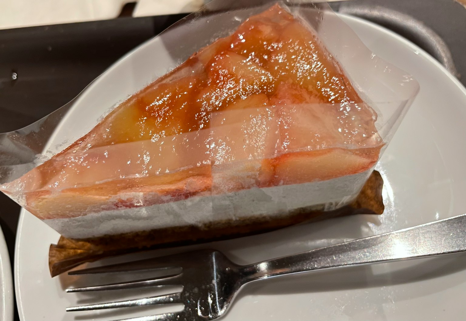 Slice of cake topped with translucent fruit jelly