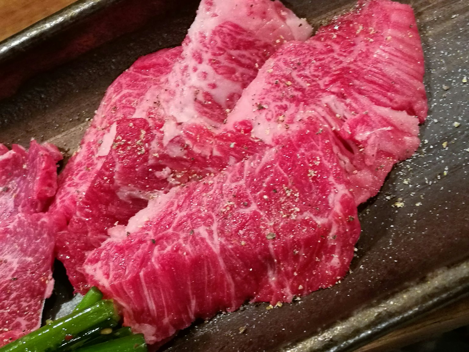 Vibrant red slices of Wagyu beef arranged on a plate