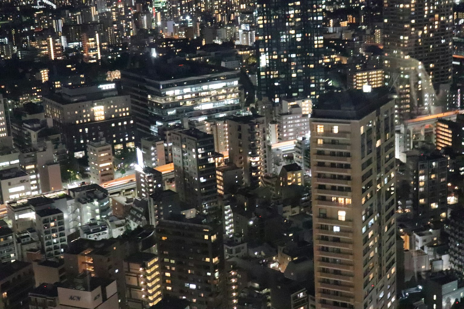 Nighttime cityscape with glowing buildings and lights