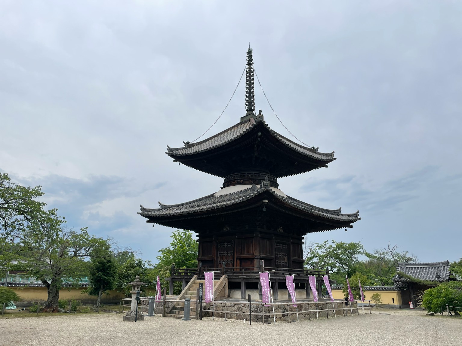Bella pagoda di tempio giapponese, struttura in legno, si staglia contro un cielo grigio