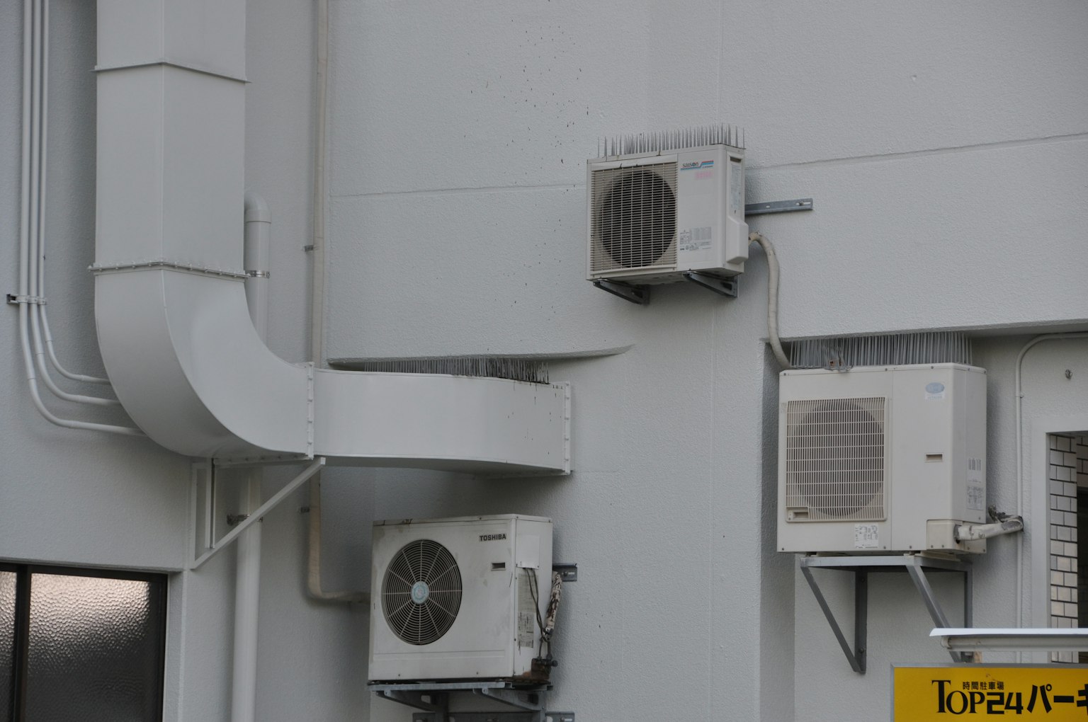 Photo of air conditioning units and ducts mounted on a wall