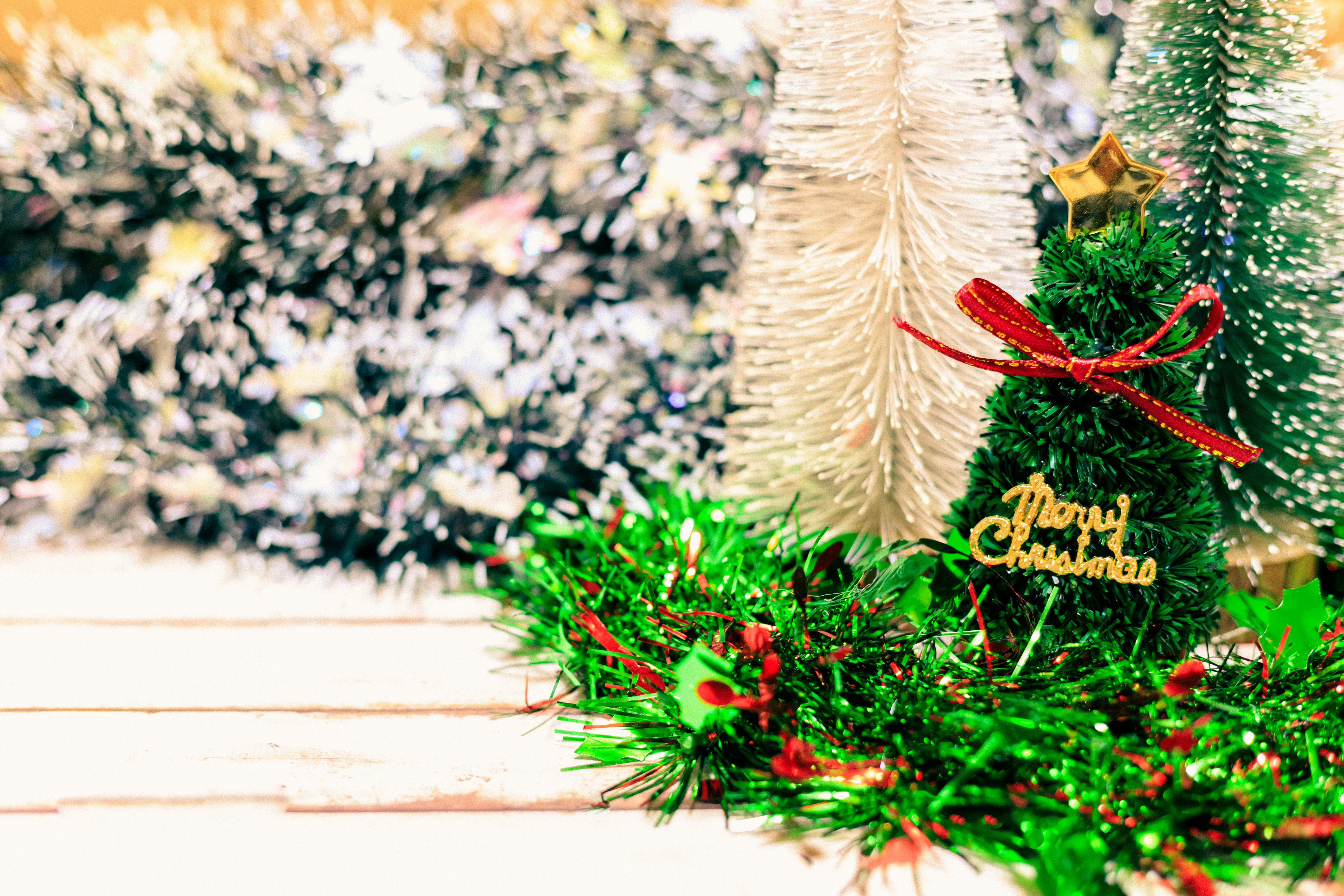 Christmas tree ornaments and wreath with pinecones on a table