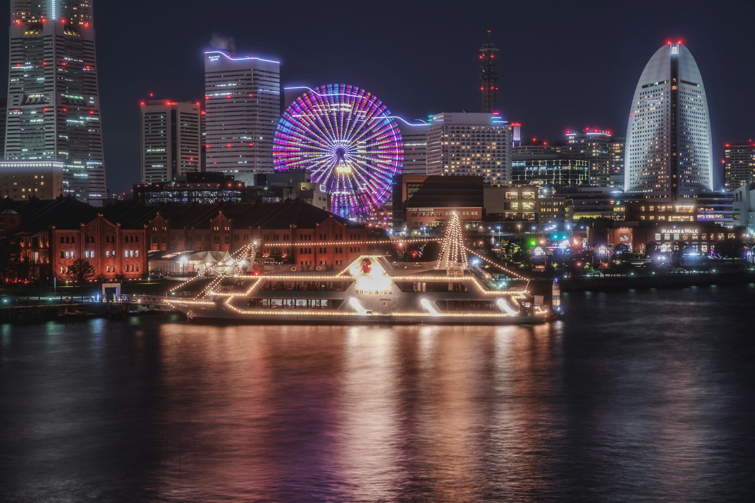 Beautiful night view of Yokohama with illuminated Ferris wheel and skyscrapers