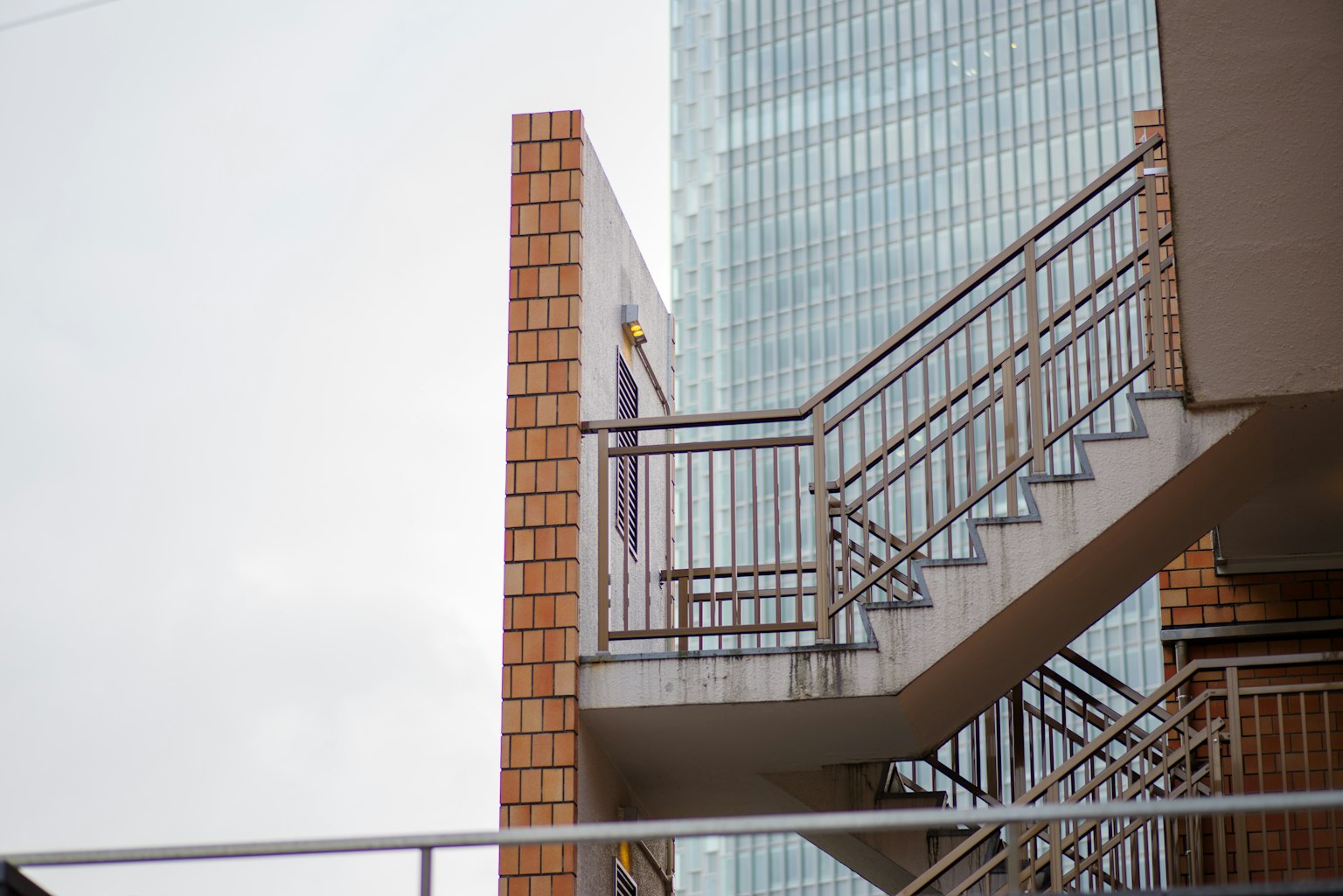 Metal staircase and brick wall outside a building