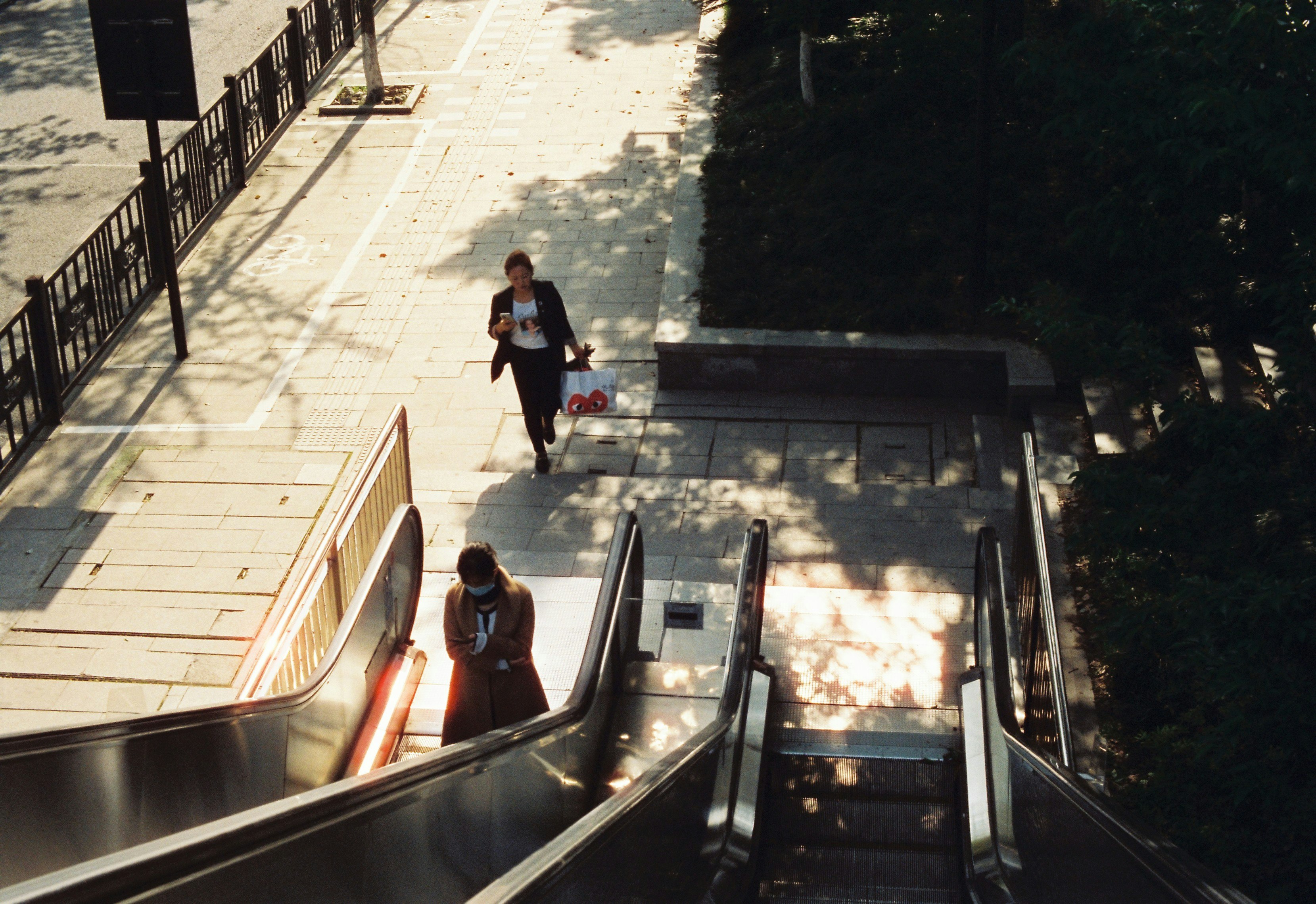 outdoor walkway with stair-step path and escalators