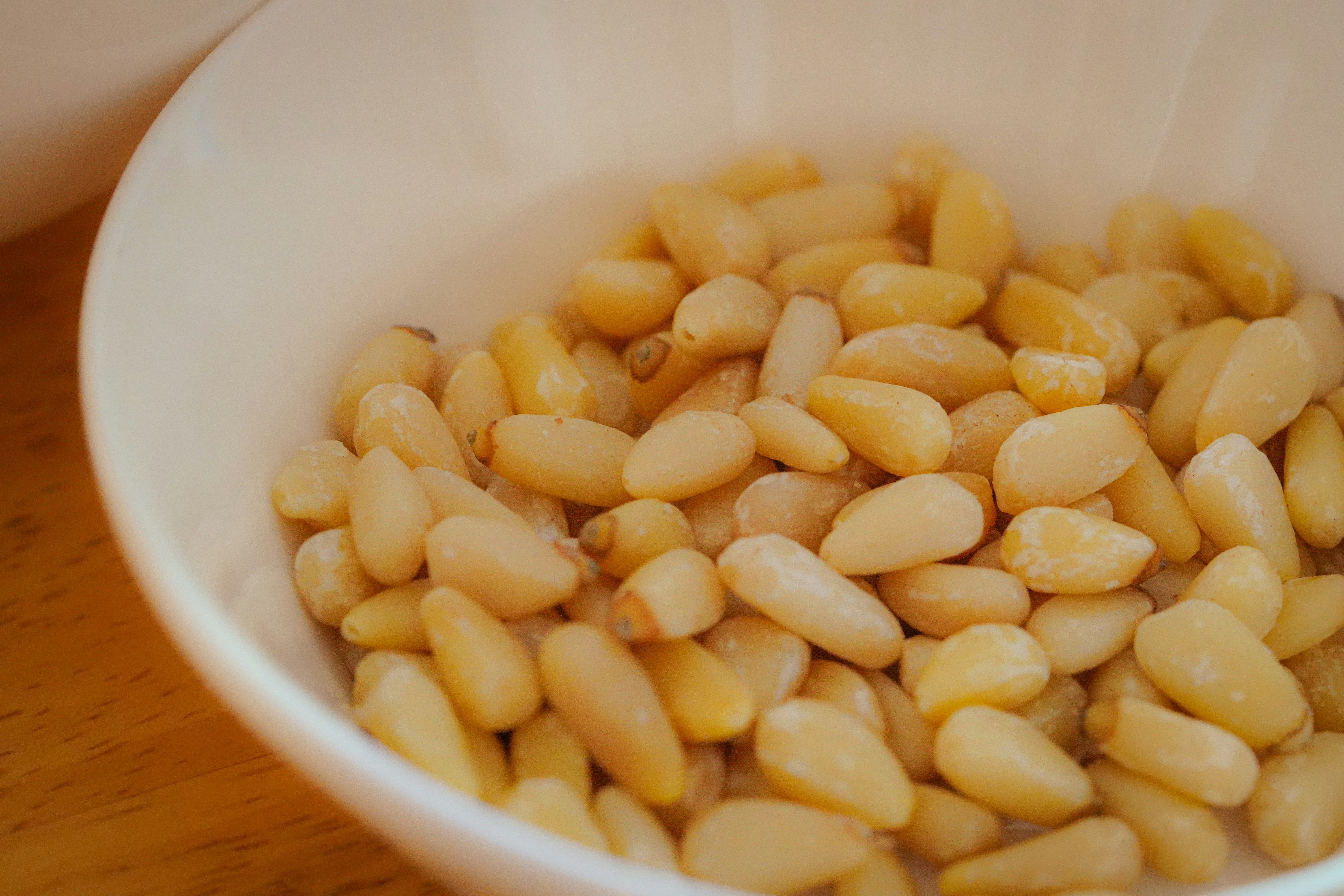 pine nuts in a white bowl