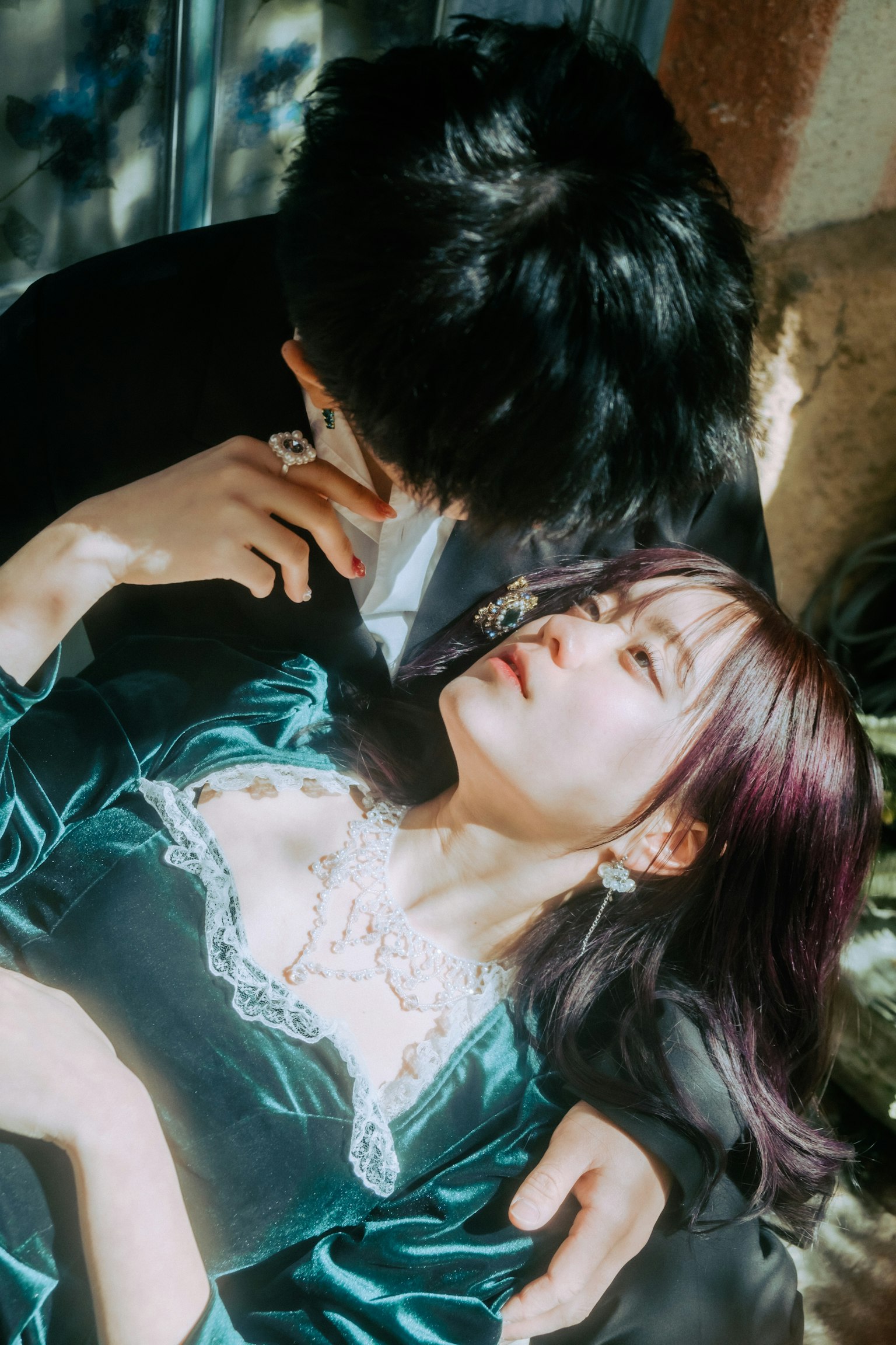 Young couple sharing an intimate moment woman in green dress man leaning close