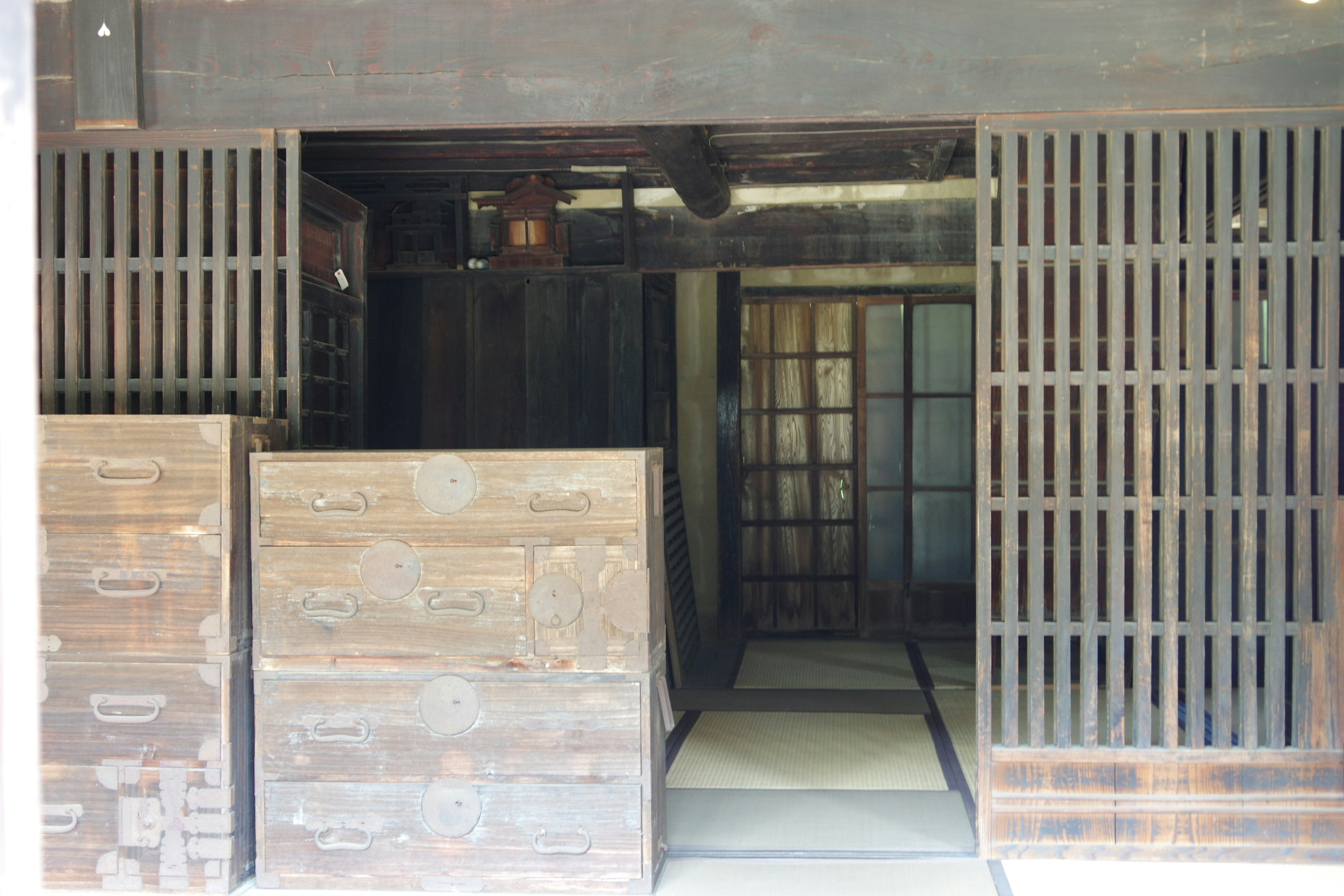 warehouse entrance with wooden slats and stacked cardboard boxes