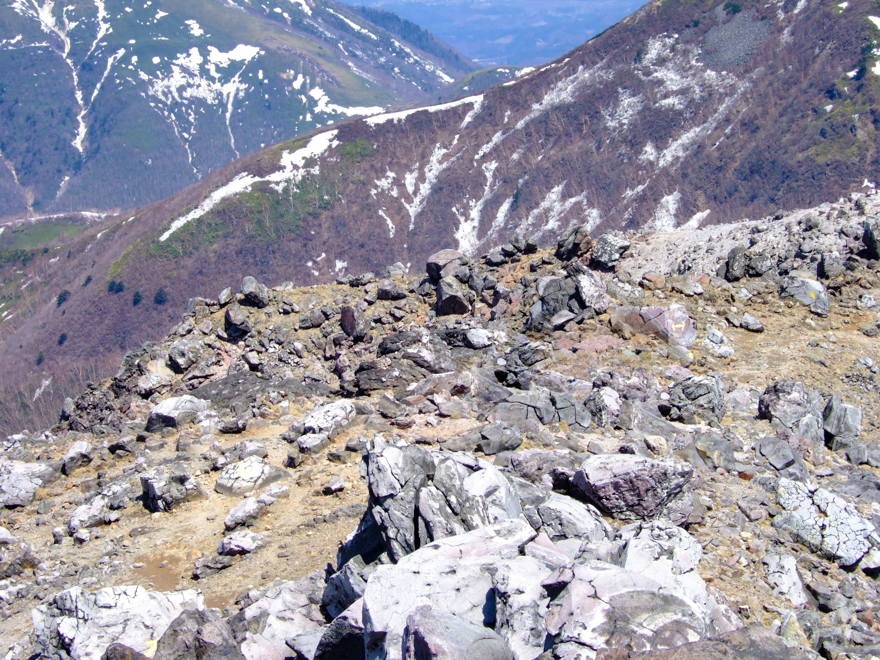 Rocky mountain trail with distant ridgeline scenery