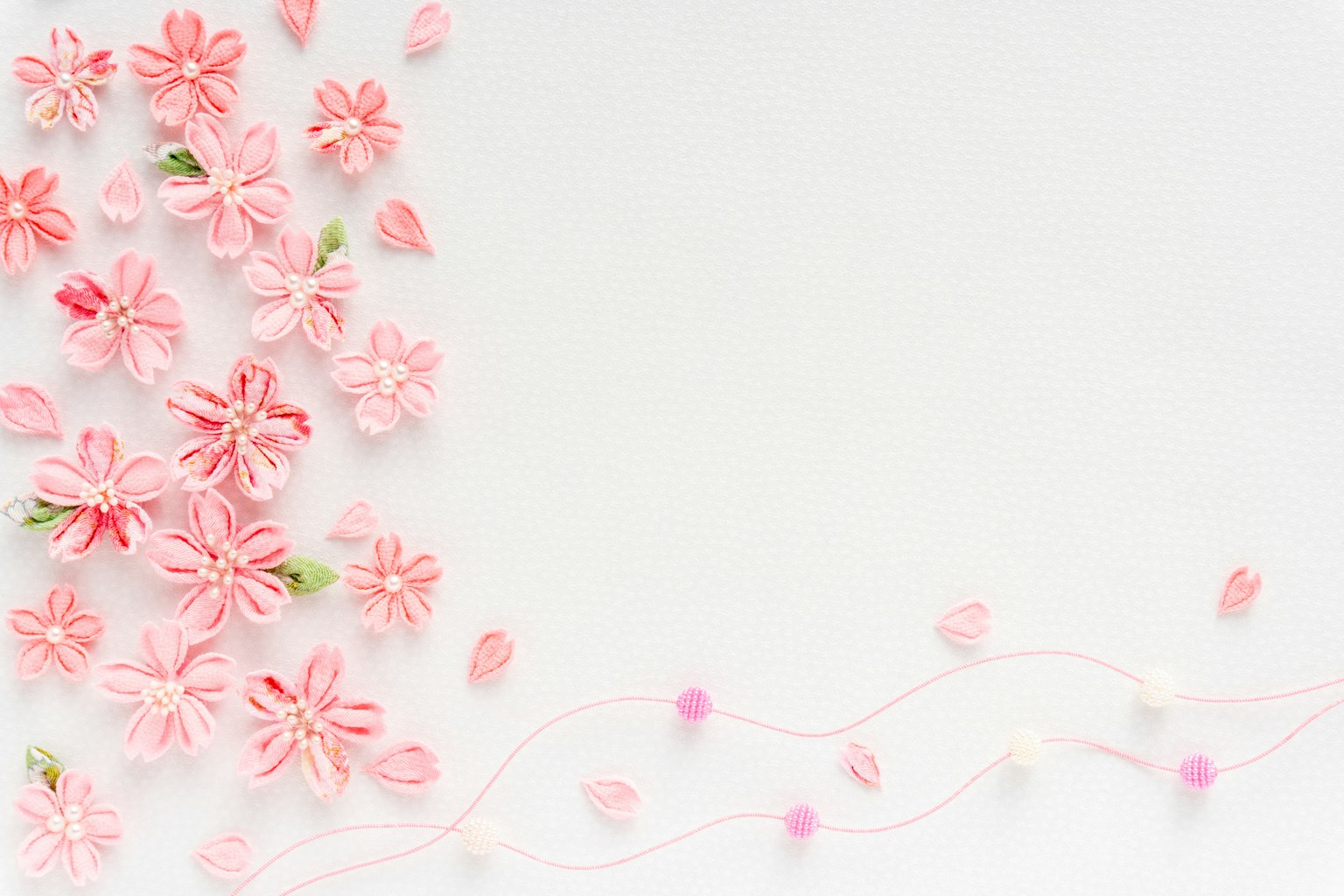 A soft pink flower arrangement on a white background