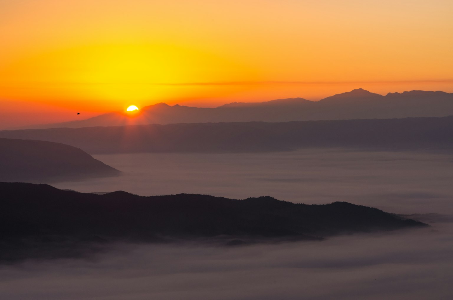 Stunning view of the sunrise over mountains and mist